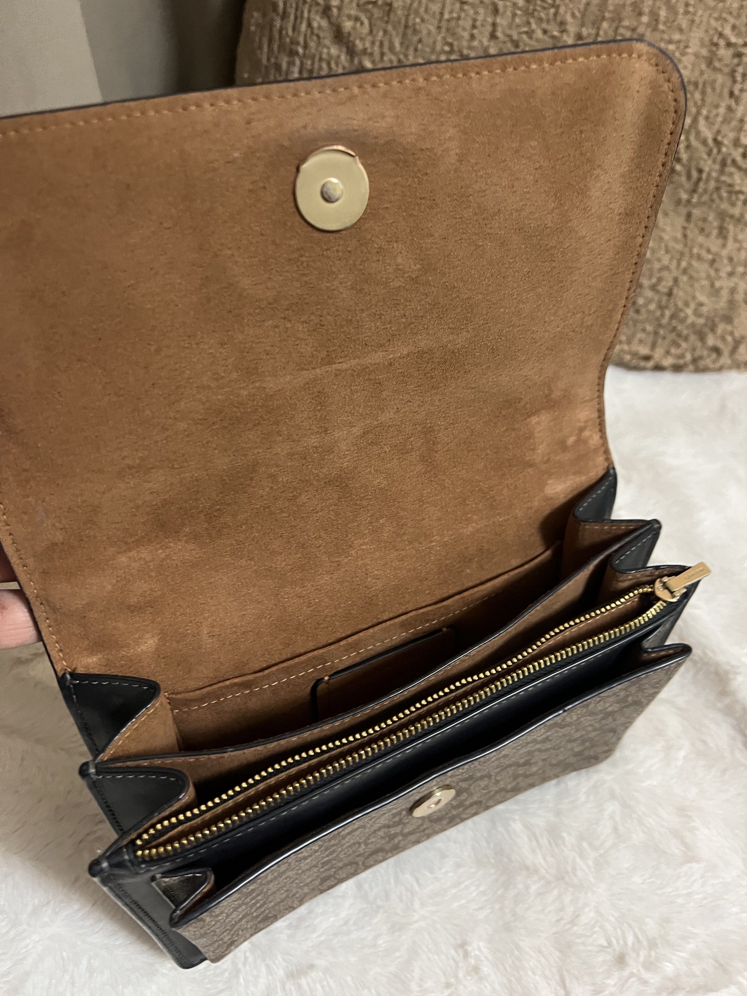 Coach Signature Chain Bag (Category: Luxury Bags & Wallets) located in Manila. Submitted by cluttercrushers (Listing ID 1421150247, Image 3). Description: - Authentic Coach handbag - Signature pattern and chain strap - Black flap with gold hardware - Interior features a zippered pocket and Coach tag - Includes care card - Classic design, versatile for any occasion.