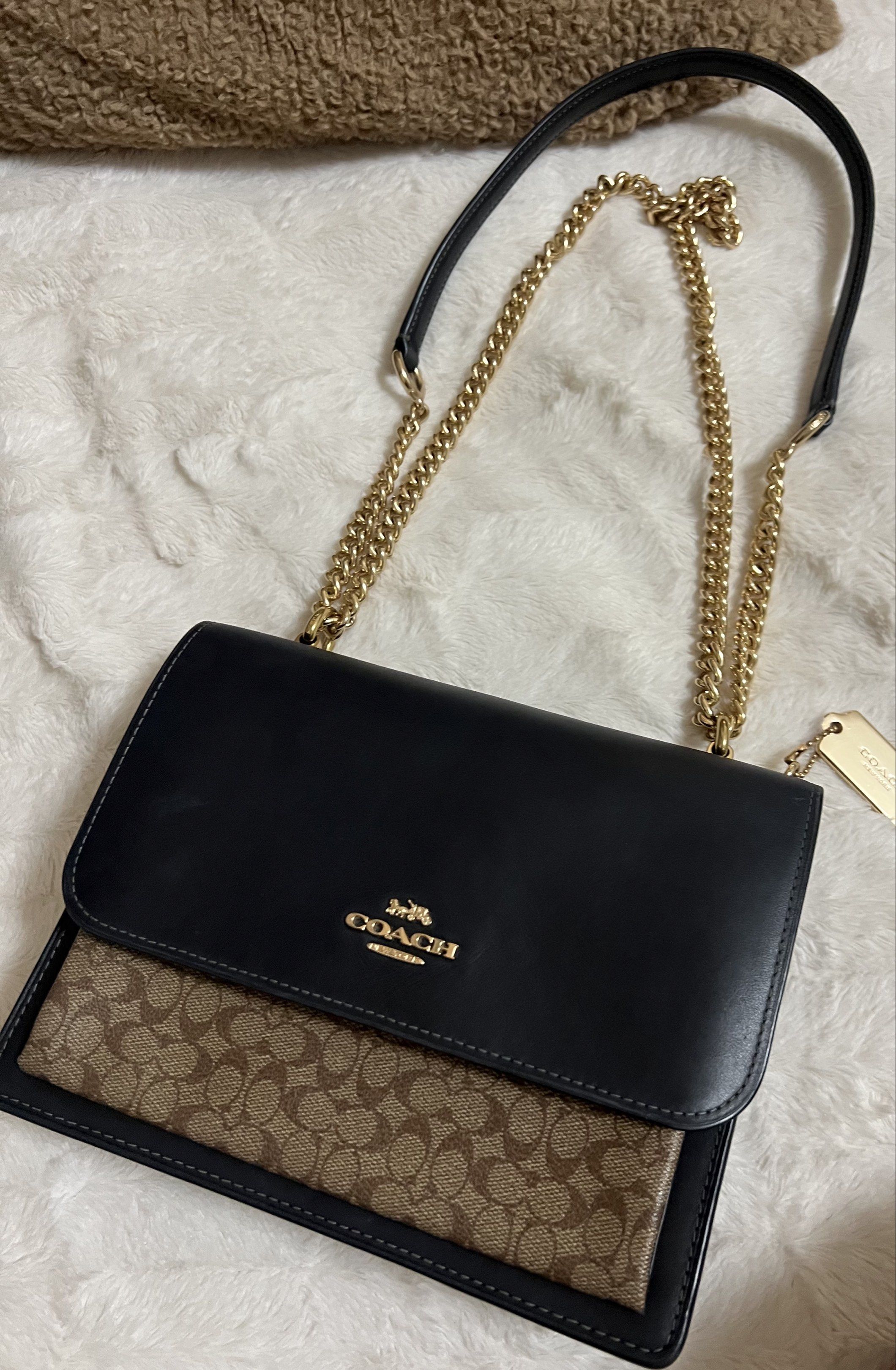 Coach Signature Chain Bag (Category: Luxury Bags & Wallets) located in Manila. Submitted by cluttercrushers (Listing ID 1421150247, Image 1). Description: - Authentic Coach handbag - Signature pattern and chain strap - Black flap with gold hardware - Interior features a zippered pocket and Coach tag - Includes care card - Classic design, versatile for any occasion.