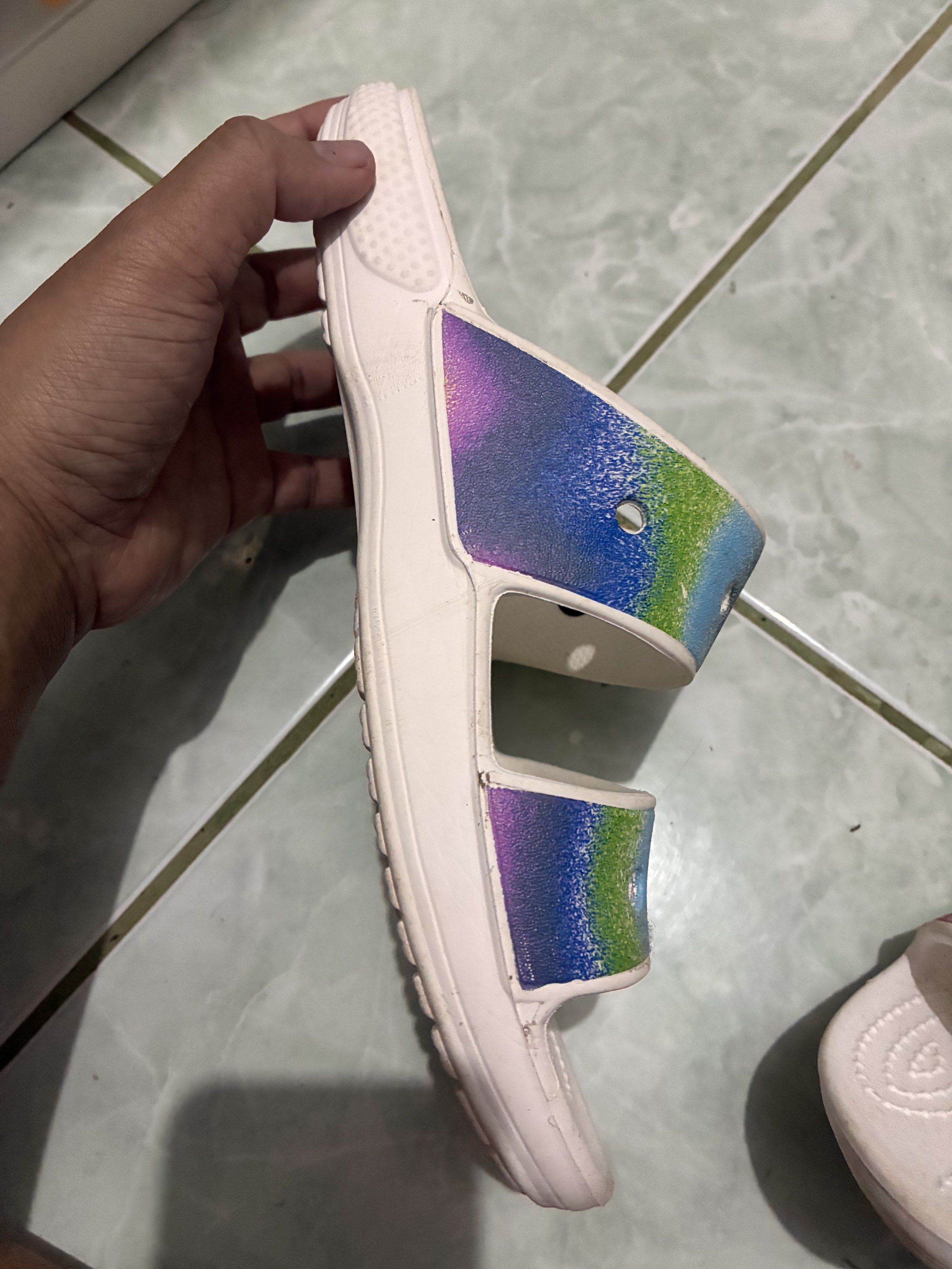 Crocs Women's Sandals Size 8 (Category: Flats & Sandals) located in Legazpi City. Submitted by batutastudio (Listing ID 1421150393, Image 3). Description: - Crocs sandals - Size: W8/M6 - Design: White sandals with rainbow straps - Condition: Some wear on soles - Features: Crocs logo Thank you for viewing this item! 😊 This is a preloved personal piece and will be sold as is. Please refer to the photos for the exact condition, as the item may show