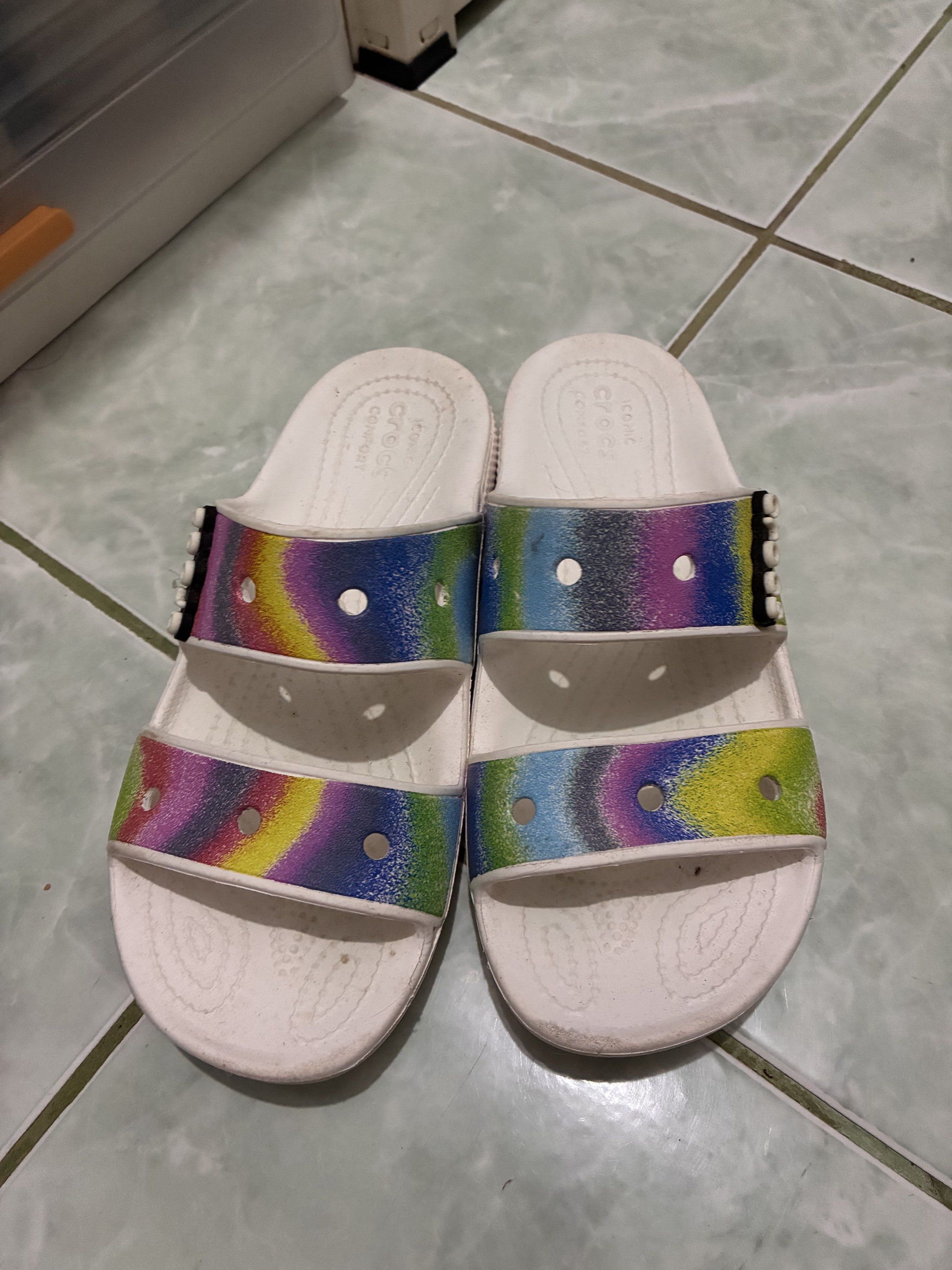 Crocs Women's Sandals Size 8 (Category: Flats & Sandals) located in Legazpi City. Submitted by batutastudio (Listing ID 1421150393, Image 1). Description: - Crocs sandals - Size: W8/M6 - Design: White sandals with rainbow straps - Condition: Some wear on soles - Features: Crocs logo Thank you for viewing this item! 😊 This is a preloved personal piece and will be sold as is. Please refer to the photos for the exact condition, as the item may show