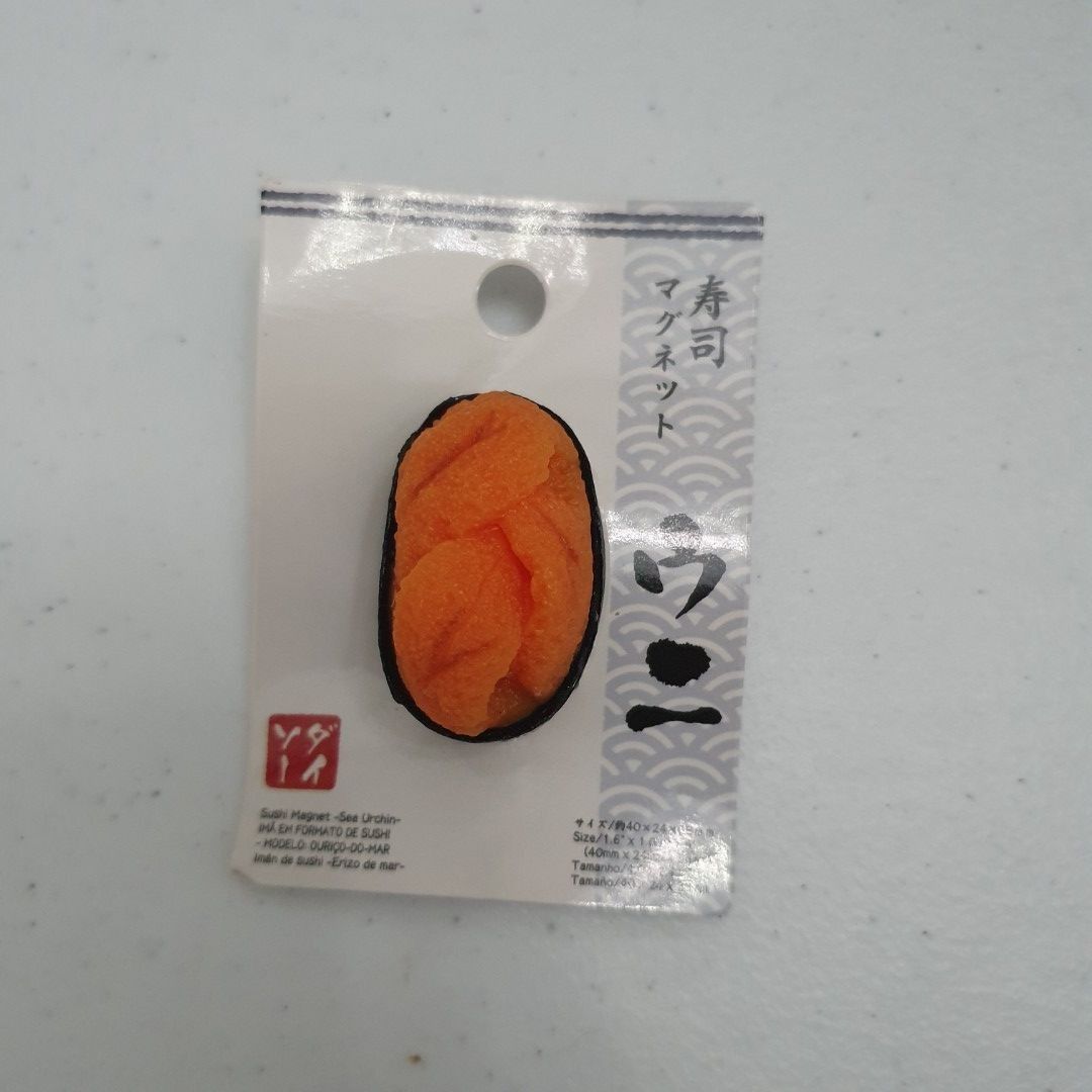 Daiso Sushi Magnet sea urchin (Category: Designer & Blind Box Toys) located in Paranaque City. Submitted by cobien (Listing ID 1421225432, Image 1). Description: - Daiso Japan sushi-shaped magnet - Features sushi with orange topping and black seaweed - White magnet back - Includes original packaging - Packaging has Japanese text and barcode.