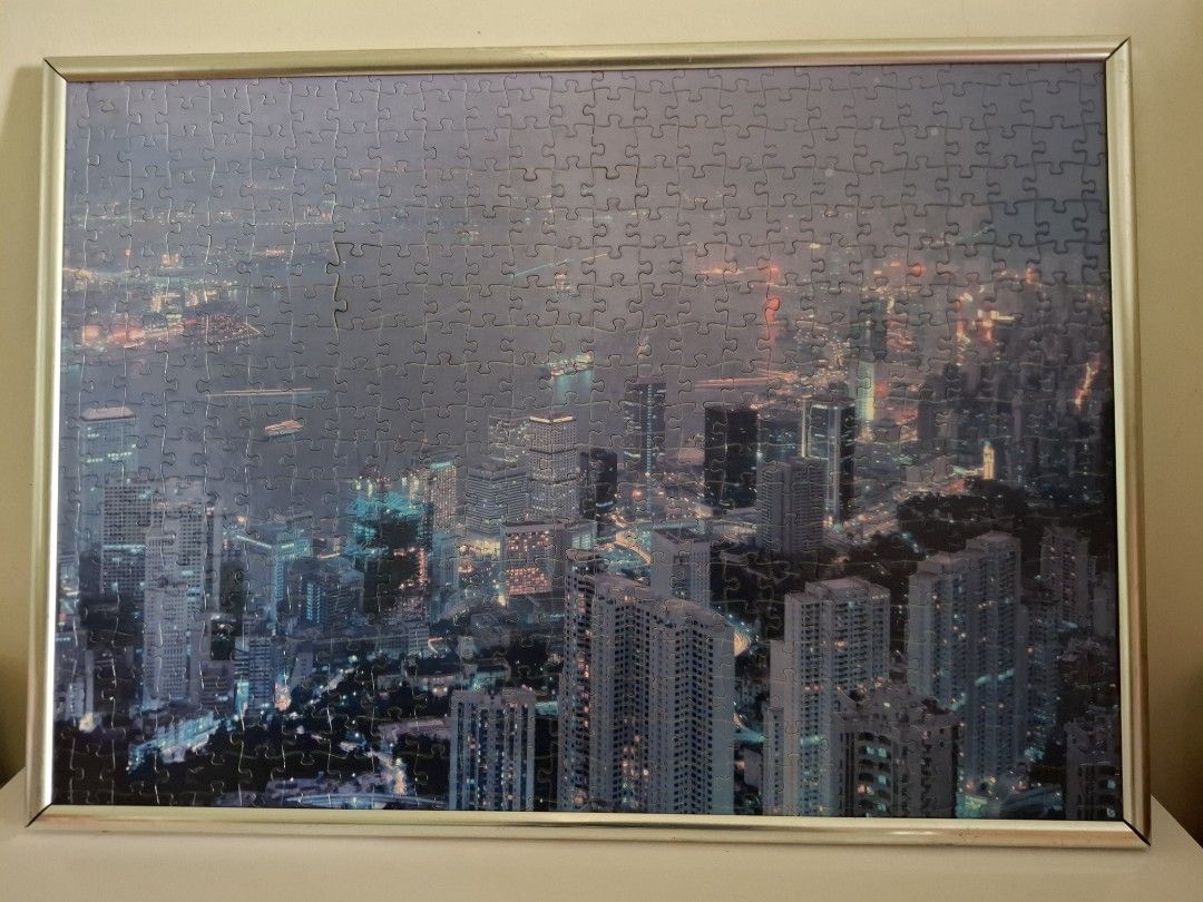 Framed Cityscape Puzzle (Category: Frames & Pictures) located in Cavite. Submitted by molinajegg62356 (Listing ID 1421147609, Image 1). Description: - Framed cityscape puzzle - Depicts a nighttime city scene - Features illuminated buildings and lights - Silver-colored frame - Includes backing and wire for hanging Size: 15"x 21" MOP: Bank transfer & Gcash MOD: J&T & Lalamove .