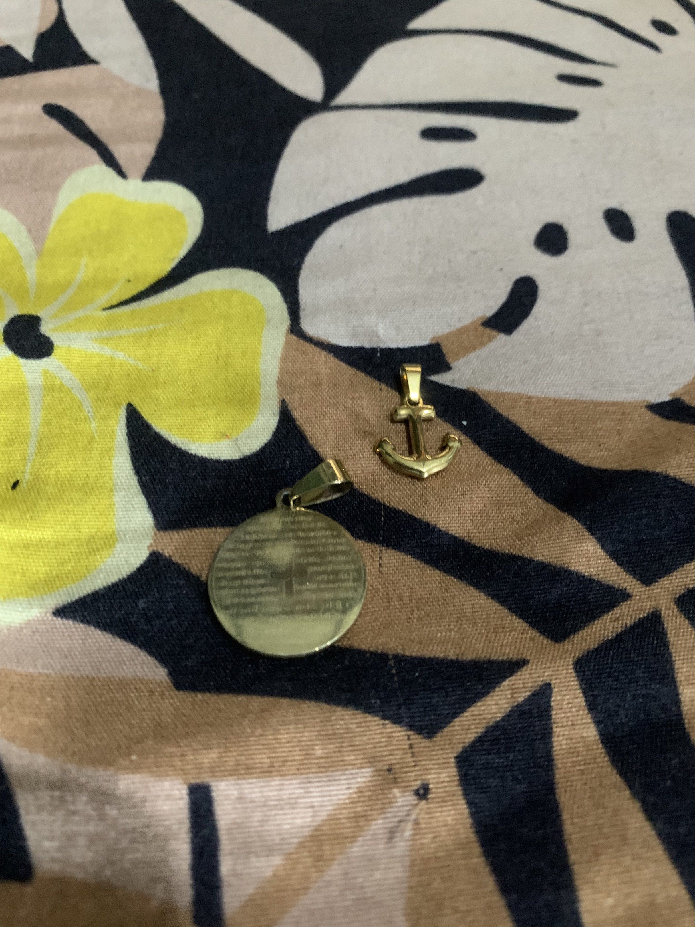 Gold-Colored Religious Pendants and anchor (Category: Charms) located in Manila. Submitted by declutteringog7 (Listing ID 1421170329, Image 2). Description: - Set of two gold-colored pendants. - Includes: - Round pendant with cross and text. - Anchor pendant. - Made of metal. - Both pendants have loops for attaching to a chain..