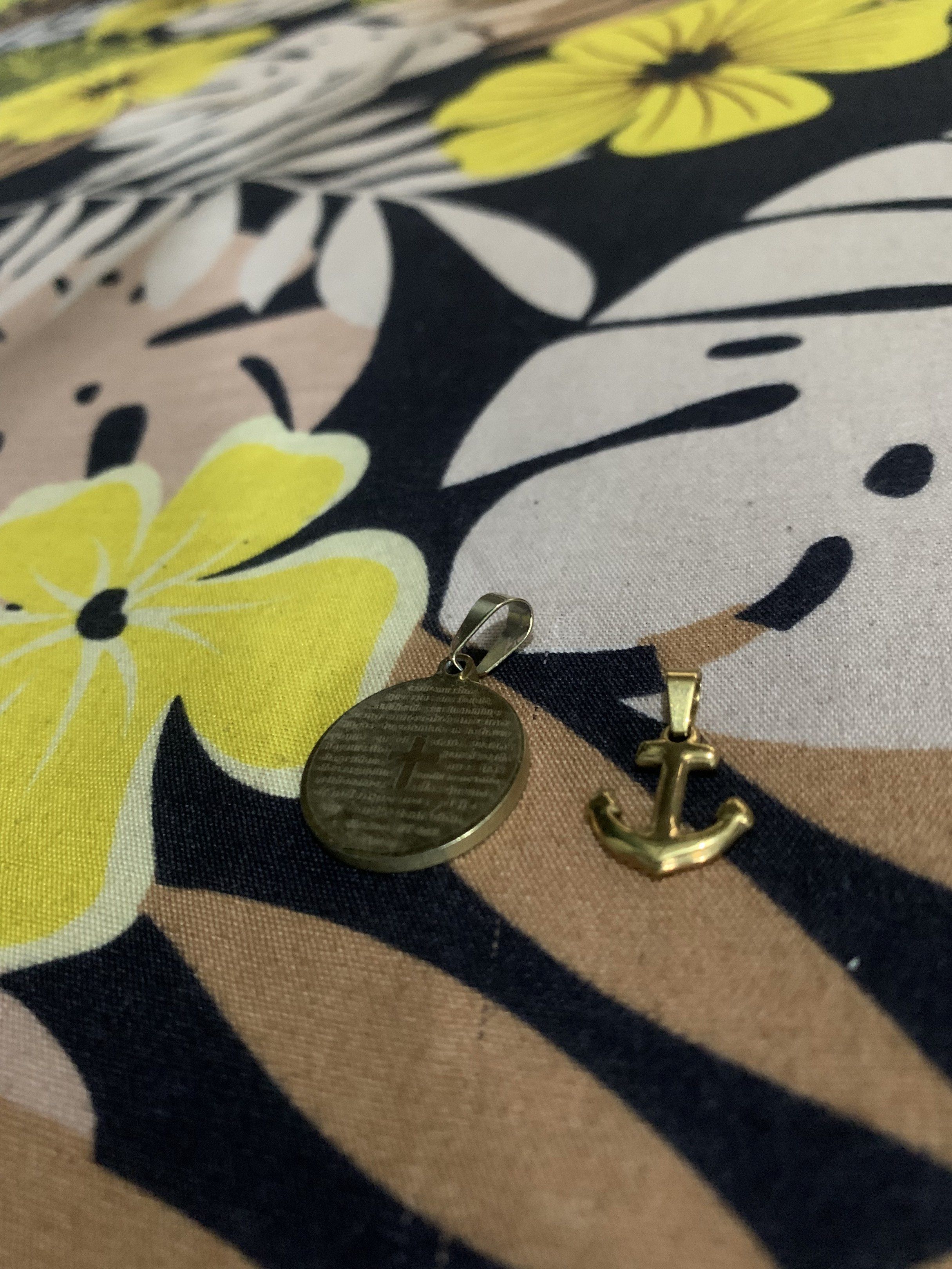 Gold-Colored Religious Pendants and anchor (Category: Charms) located in Manila. Submitted by declutteringog7 (Listing ID 1421170329, Image 3). Description: - Set of two gold-colored pendants. - Includes: - Round pendant with cross and text. - Anchor pendant. - Made of metal. - Both pendants have loops for attaching to a chain..