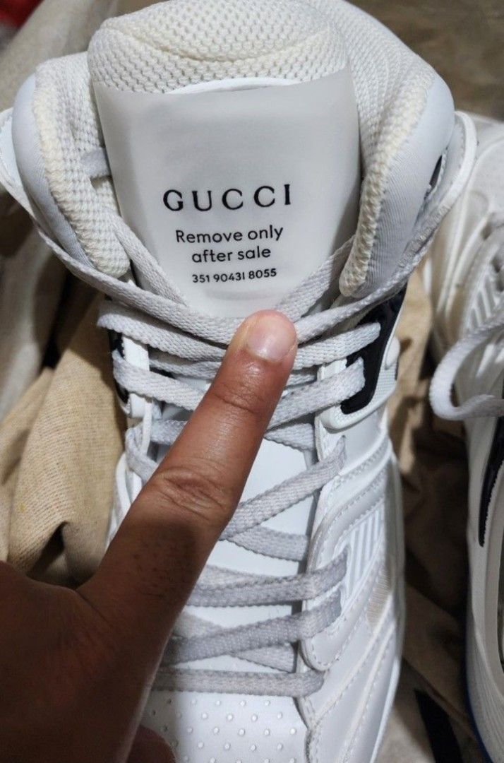 Gucci Basket High-Top Sneakers - White (Category: Sneakers) located in Manila. Submitted by microus (Listing ID 1421162613, Image 3). Description: - Authentic Gucci Basket high-top sneakers - Color: White - Size: 7 but runs big - Features Gucci logo on tongue and side - Blue rubber sole with Gucci logo and bee design - Includes original box.