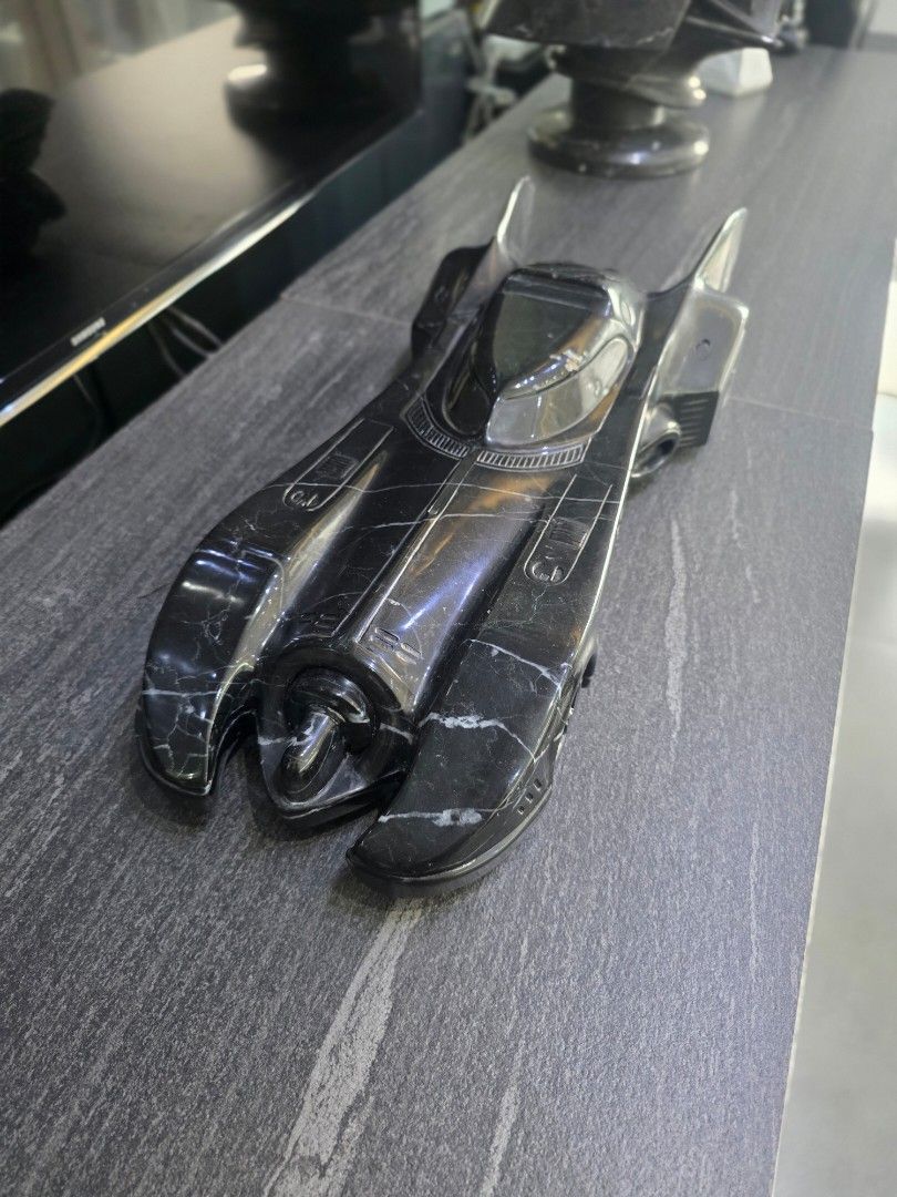 Hand Carved 1989 Batman Batmobile in Solid Nero Marquina Marble (Category: Vehicle & Diecast Models) located in Mandaluyong City. Submitted by lbear29 (Listing ID 1421130612, Image 3). Description: Hand carved from a single block of marble with exceptional details - Collector's item - One of a kind Marble fan art - Batmobile collectible - Sleek, dark design - Intricate detailing - Iconic Batmobile shape - Visible wheels and aerodynamic features -