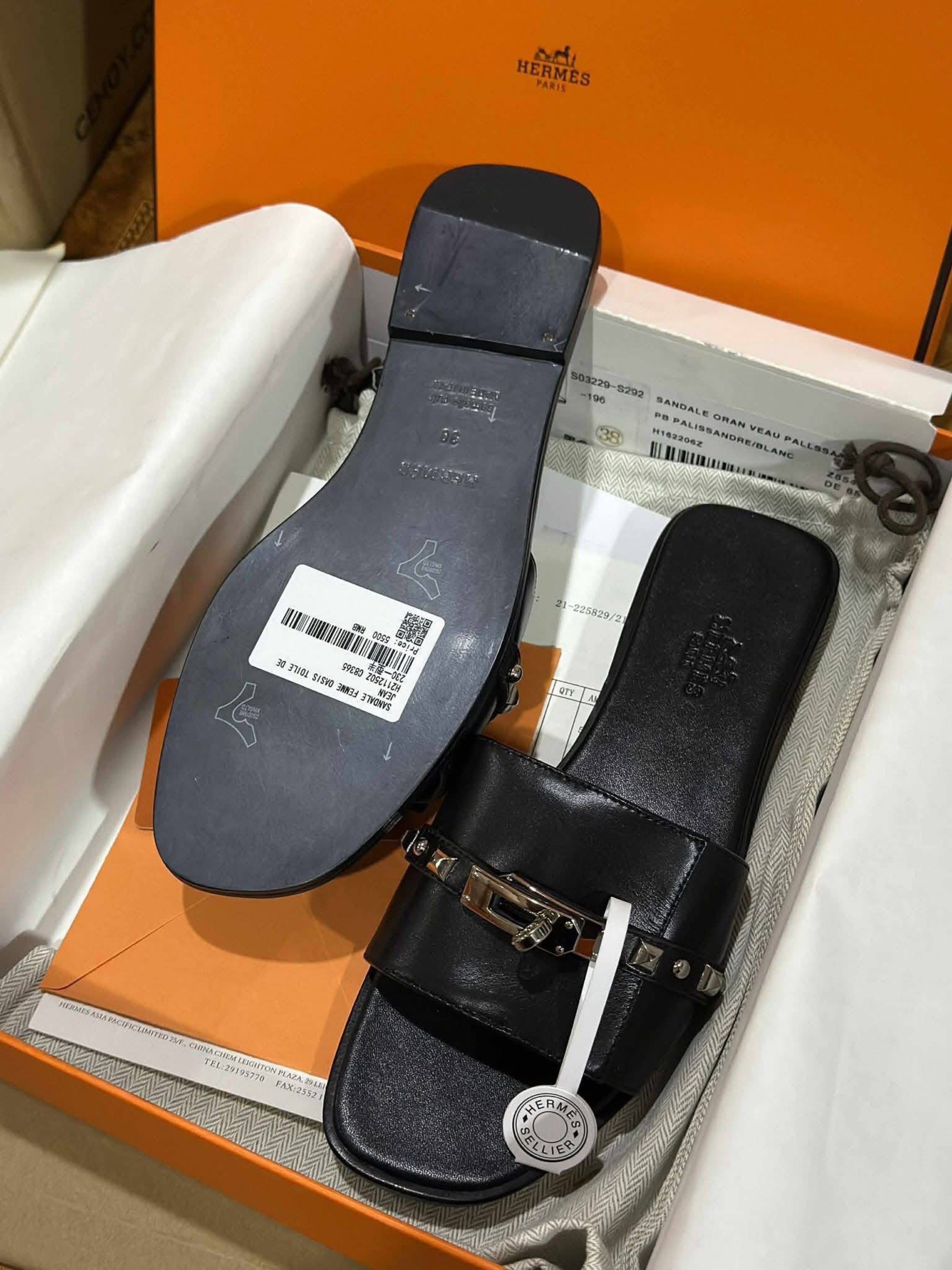 Hermes Oran Veau Pallisandre Sandals (Category: Sneakers & Footwear) located in Manila. Submitted by rosmiemuno16247 (Listing ID 1421155655, Image 1). Description: - Authentic Hermes Oran sandals - Color: Black - Size: 38 - Features iconic buckle and studded details - Includes original box and packaging - Made in Italy - Stylish and comfortable.