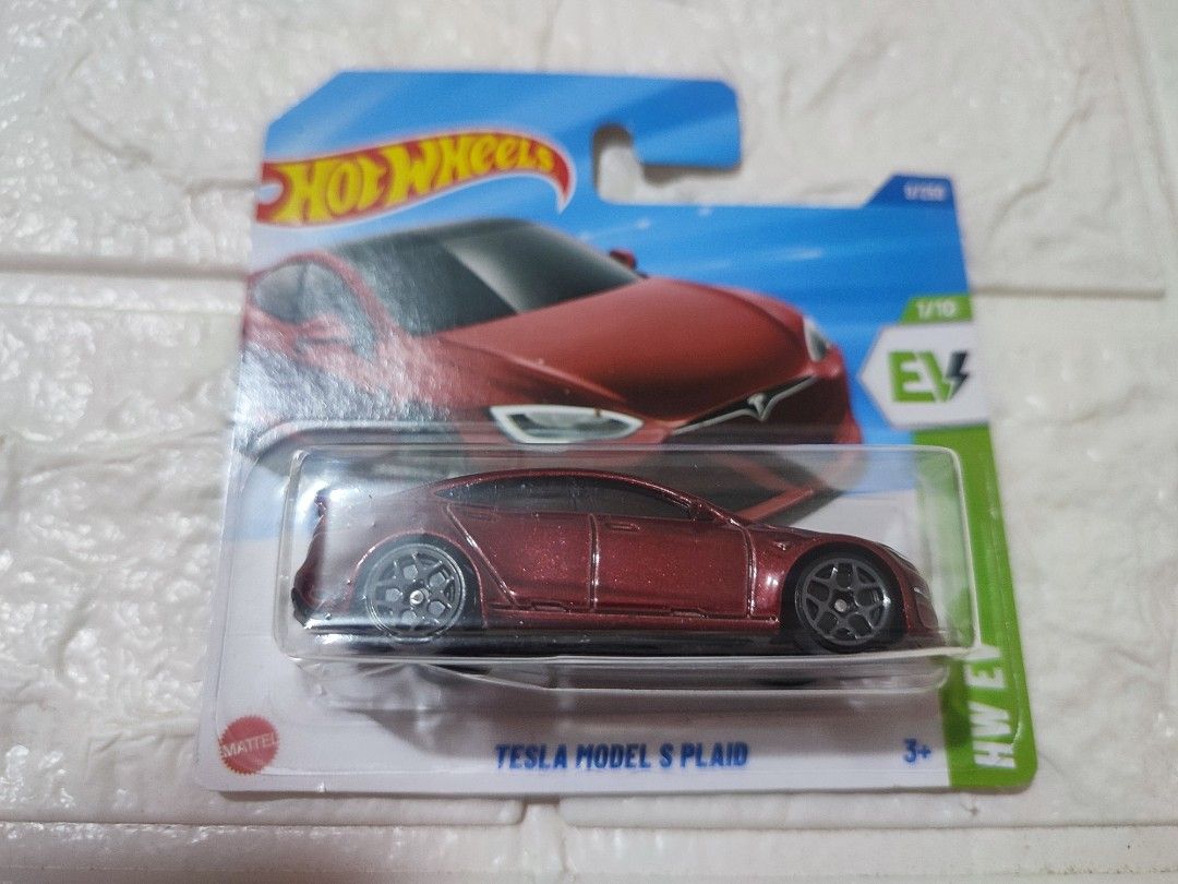 Hot Wheels Tesla Model S Plaid (Category: Vehicle & Diecast Models) located in Narvacan. Submitted by jigger85 (Listing ID 1421202345, Image 2). Description: - Hot Wheels Tesla Model S Plaid diecast car - Color: Red - Comes in original packaging - Part of the HW EV series - Scale: 1/10 - Suitable for ages 3 and up.