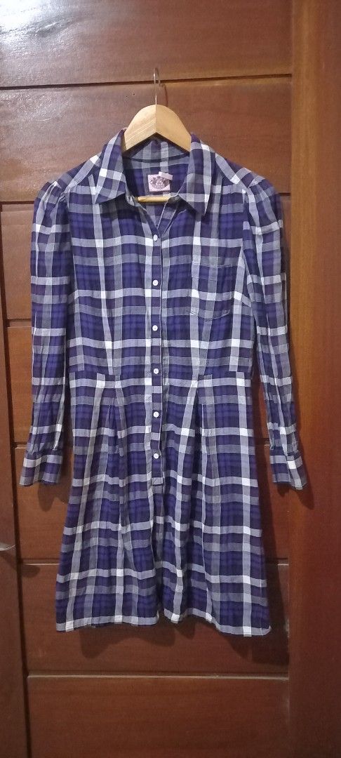 Juicy Couture Plaid Shirt (Category: Shirts) located in San Pablo. Submitted by lheyab (Listing ID 1421244139, Image 1). Description: - Juicy Couture plaid shirt - Colors: Blue, white, and purple - Features: Long sleeves, button-down front, collared neckline - Size: 2 - Stylish and versatile.