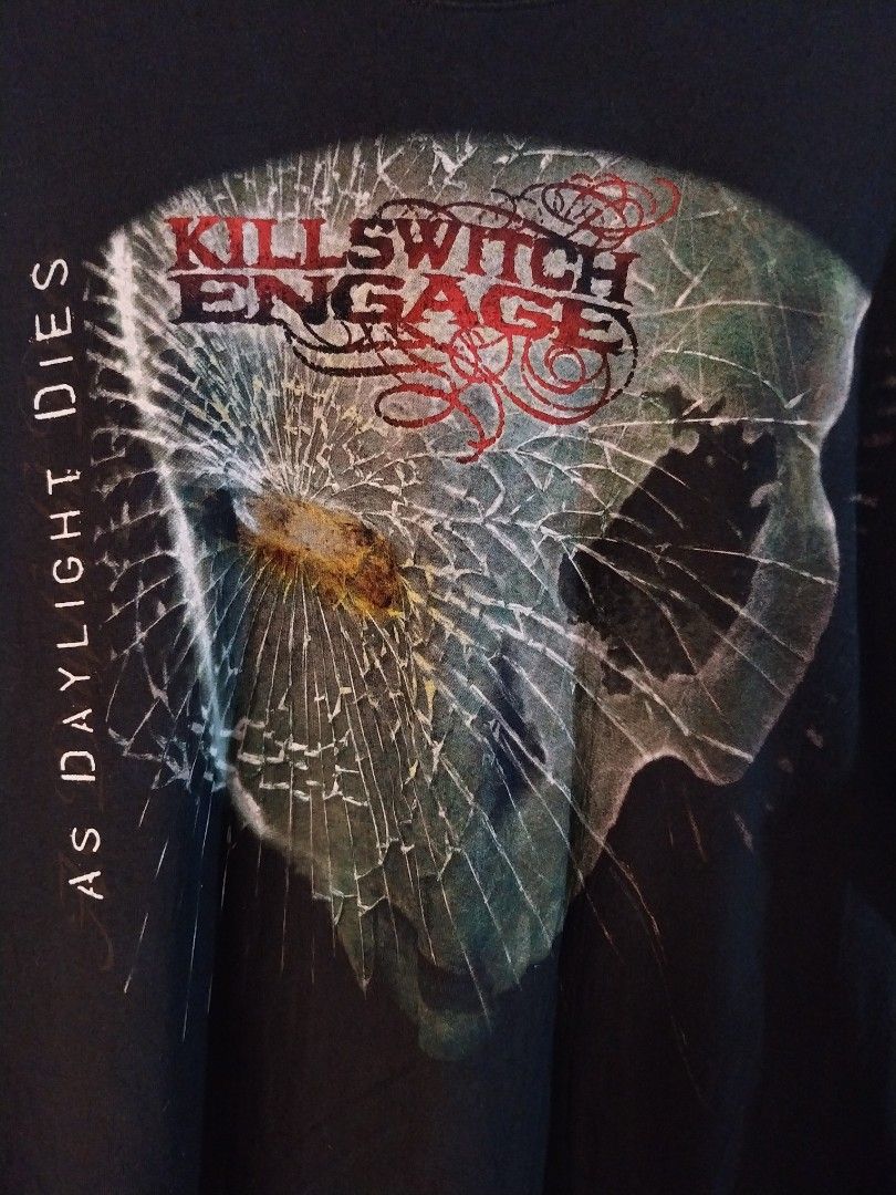 Killswitch Engage As Daylight Dies Band Tee shirt Licensed and dated (Category: Tshirts & Polo Shirts ) located in Zamboanga. Submitted by thekeepersph (Listing ID 1421225026, Image 2). Description: - Killswitch Engage t-shirt - Features "As Daylight Dies" album art - Black crew neck - Red and white band name print - Shirt is on a wooden hanger.