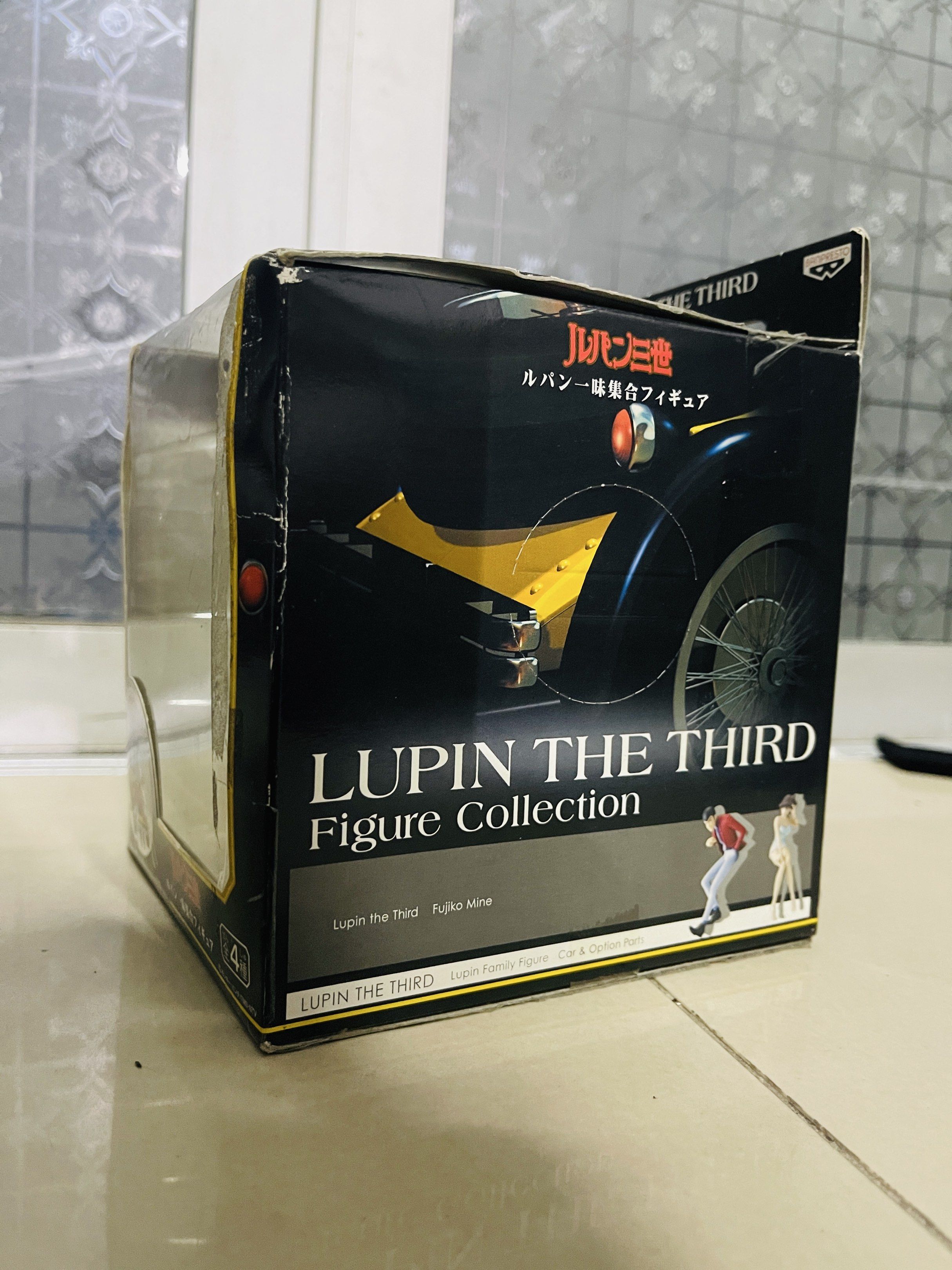Lupin the Third Figure Collection (Category: Figurines & Statues) located in Caloocan City. Submitted by theoverstock101 (Listing ID 1421236982, Image 2). Description: Lupin the Third figure from the Figure Collection. The figure features Lupin sitting infront of yellow car. The box shows other characters from the series. The box has some wear and tear. The figure is still sealed inside the box..