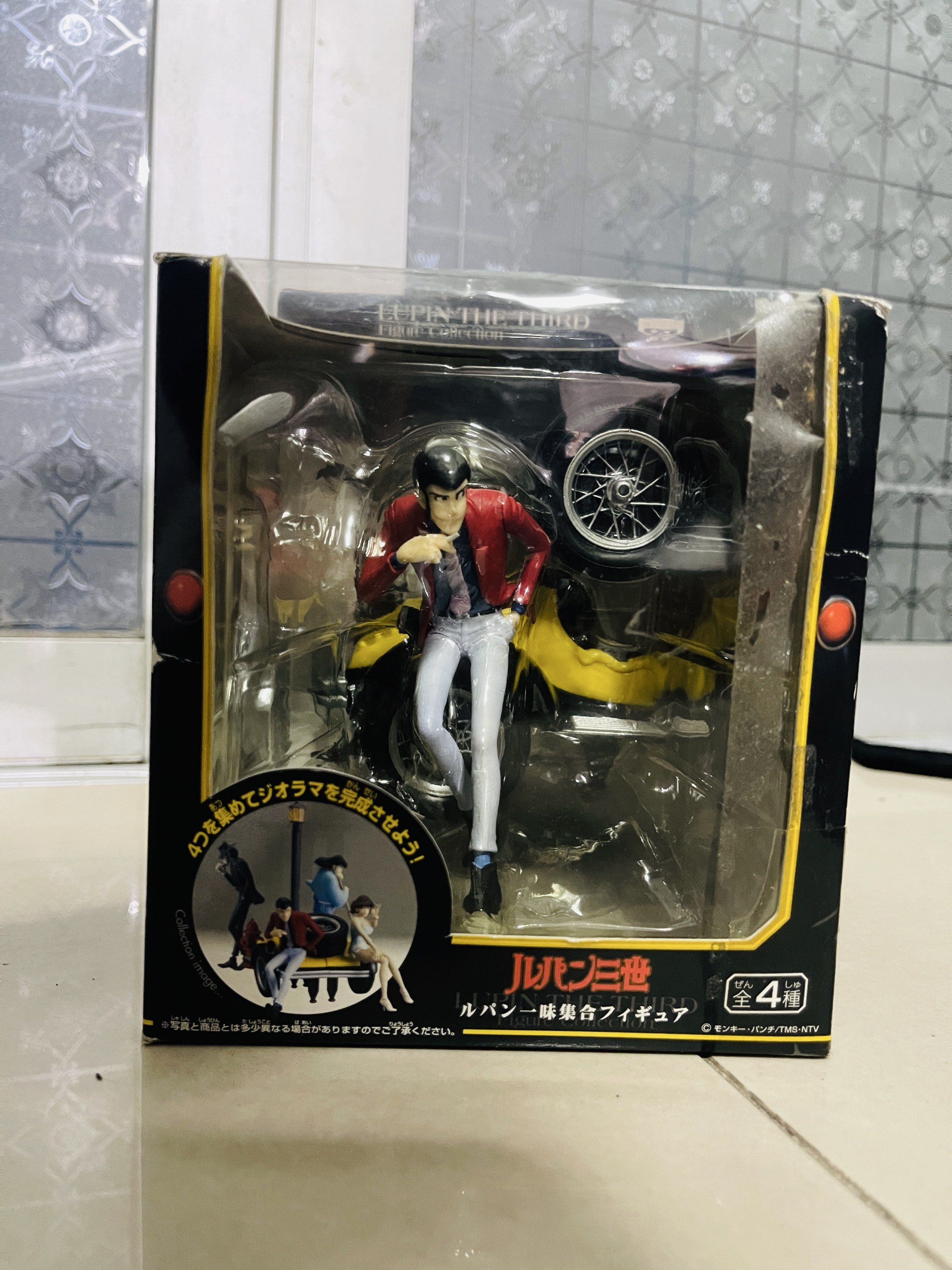 Lupin the Third Figure Collection (Category: Figurines & Statues) located in Caloocan City. Submitted by theoverstock101 (Listing ID 1421236982, Image 1). Description: Lupin the Third figure from the Figure Collection. The figure features Lupin sitting infront of yellow car. The box shows other characters from the series. The box has some wear and tear. The figure is still sealed inside the box..