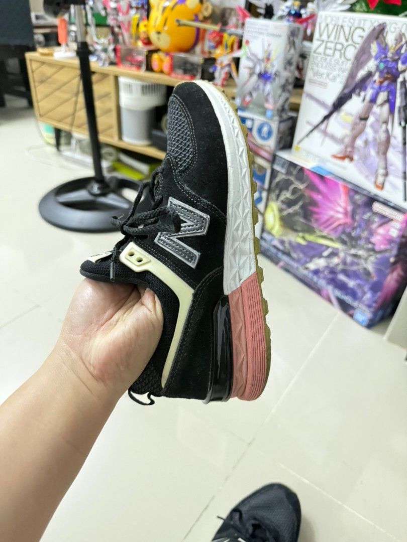 New Balance 574S Black Sneakers (Category: Sneakers) located in Tanza. Submitted by wearitagainph (Listing ID 1421252178, Image 2). Description: New Balance 574S sneakers in black. Features a mesh upper with suede overlays. The shoes have a white midsole with a pink and black heel. The New Balance logo is visible on the side and tongue. Size is US 6.5, UK 39.5, and EUR 245. Made in Vietnam..