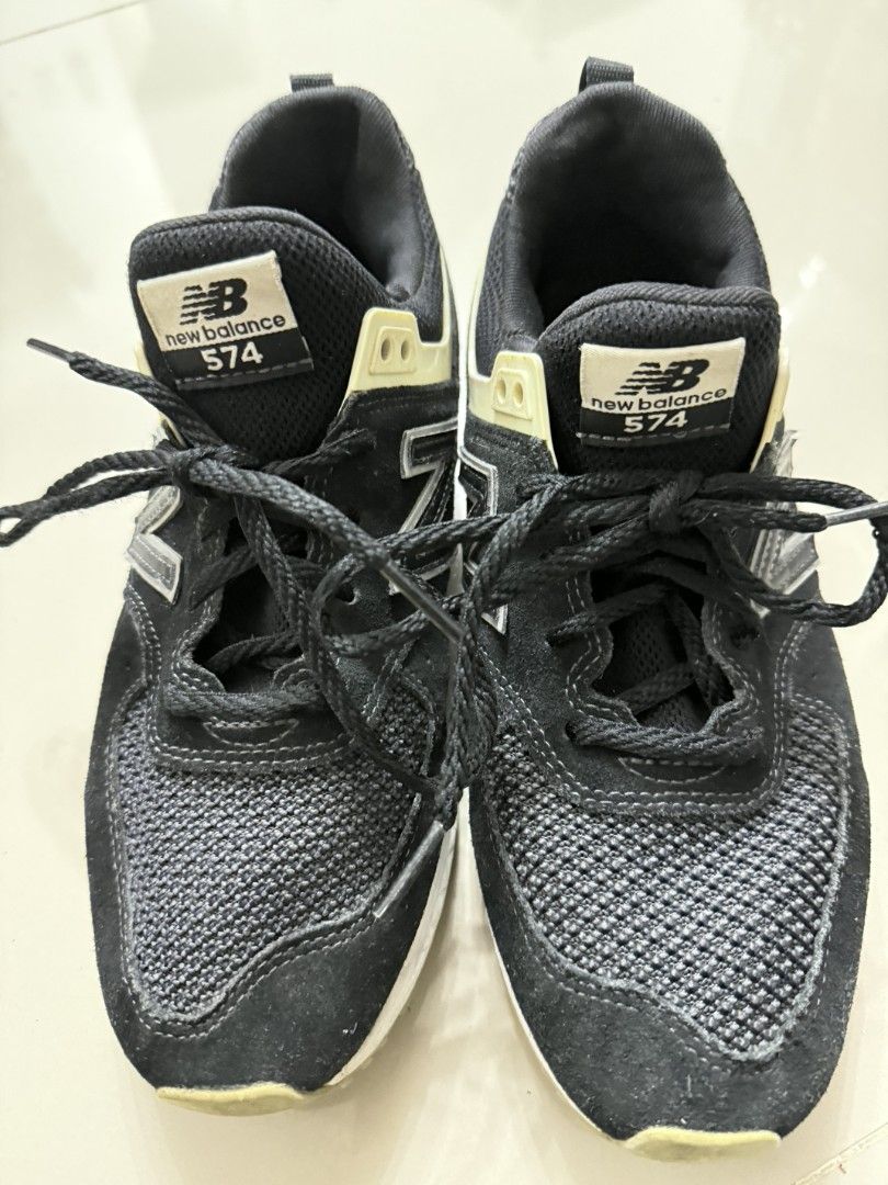 New Balance 574S Black Sneakers (Category: Sneakers) located in Tanza. Submitted by wearitagainph (Listing ID 1421252178, Image 3). Description: New Balance 574S sneakers in black. Features a mesh upper with suede overlays. The shoes have a white midsole with a pink and black heel. The New Balance logo is visible on the side and tongue. Size is US 6.5, UK 39.5, and EUR 245. Made in Vietnam..