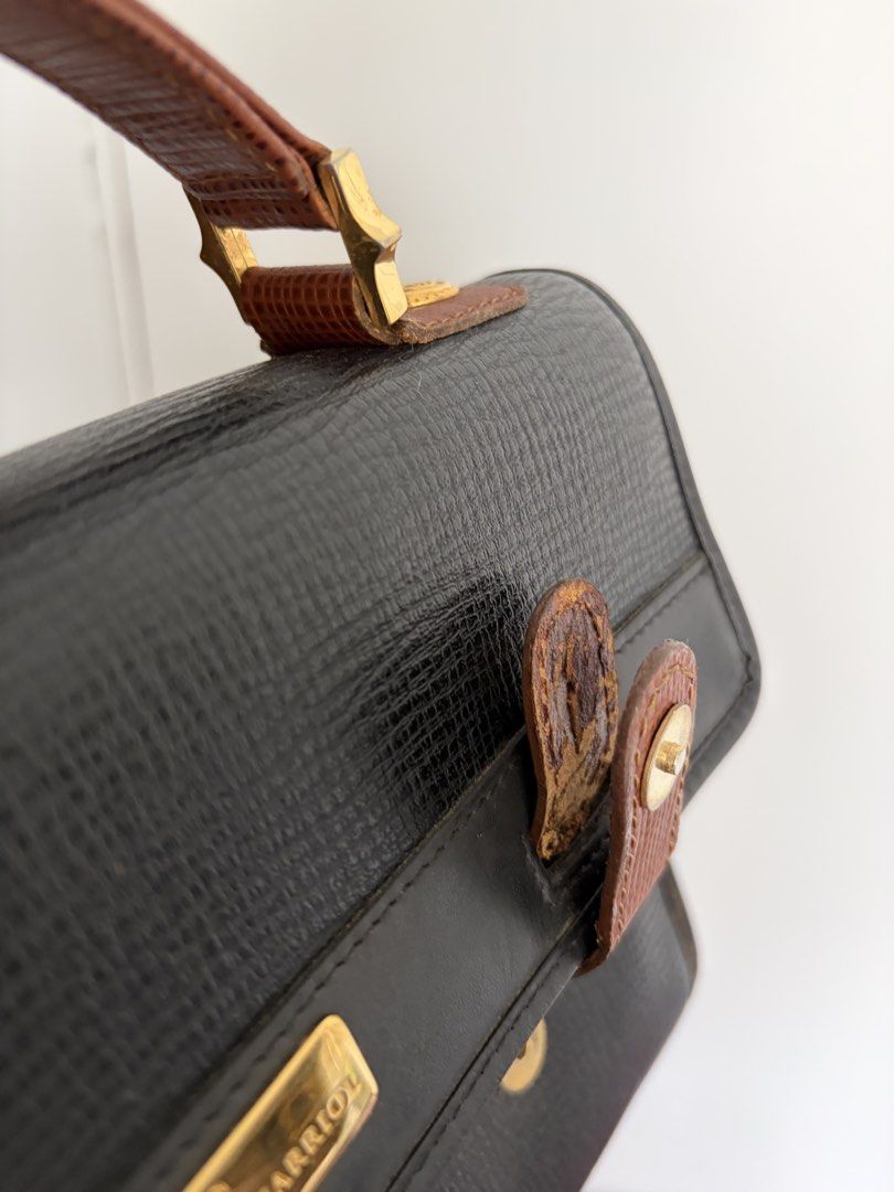 Philippe Charriol Black Handbag (Category: Luxury Bags & Wallets) located in Makati City. Submitted by lenyfelix (Listing ID 1421195665, Image 2). Description: - Philippe Charriol black handbag - Top handle - Flap closure with gold-tone clasp - Brown leather accents - Textured exterior - Gold-tone brand plaque - Minor wear on leather accents - see flaws in photo.