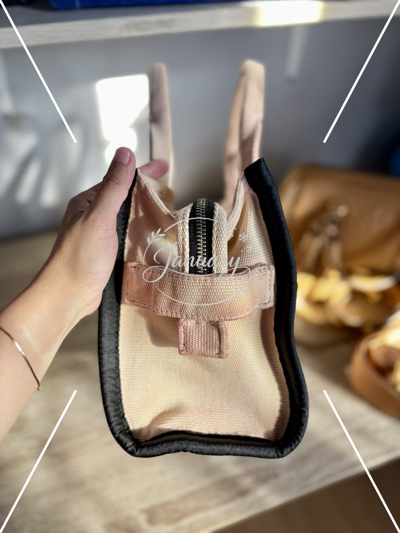 Preloved Marc Jacobs The Tote Bag in mini (Category: Luxury Bags & Wallets) located in Naguilian. Submitted by MyJanuary (Listing ID 1421235877, Image 3). Description: 💯Authentic Marc Jacobs The Tote Bag Selling low because it doesn't include any straps. What you see is what you get. Flaw is already posted - discoloration It is clean and ready to use. Mini in size. Loc: La Union MoP: Gcash MoD: LBC or Jnt - but I prefer LBC kasi it's safer.