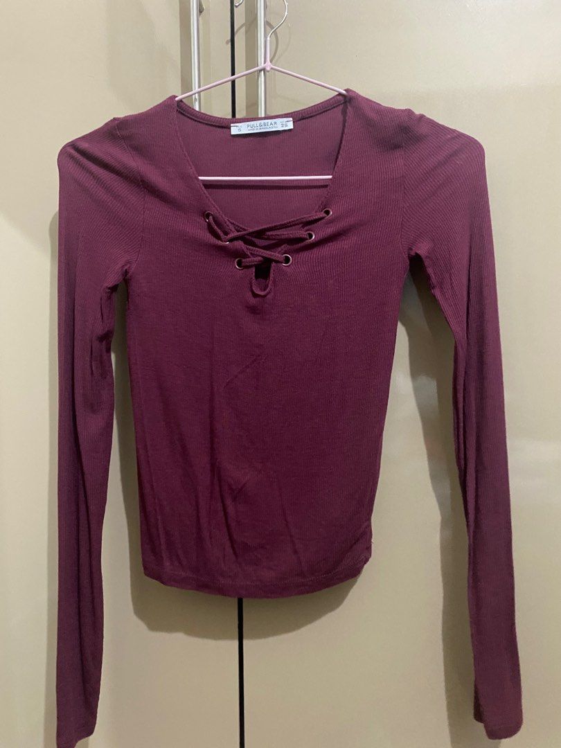 Pull&Bear Long Sleeve Top - Size S (Category: Longsleeves) located in Taguig. Submitted by jaebae_ (Listing ID 1421207885, Image 1). Description: - Pull&Bear burgundy long-sleeved top - Size: Small - Features: - Ribbed texture - Lace-up neckline - V-neck design - Material: Comfortable and stretchy - Versatile: Perfect for layering or wearing alone.