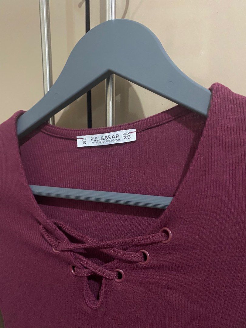 Pull&Bear Long Sleeve Top - Size S (Category: Longsleeves) located in Taguig. Submitted by jaebae_ (Listing ID 1421207885, Image 2). Description: - Pull&Bear burgundy long-sleeved top - Size: Small - Features: - Ribbed texture - Lace-up neckline - V-neck design - Material: Comfortable and stretchy - Versatile: Perfect for layering or wearing alone.