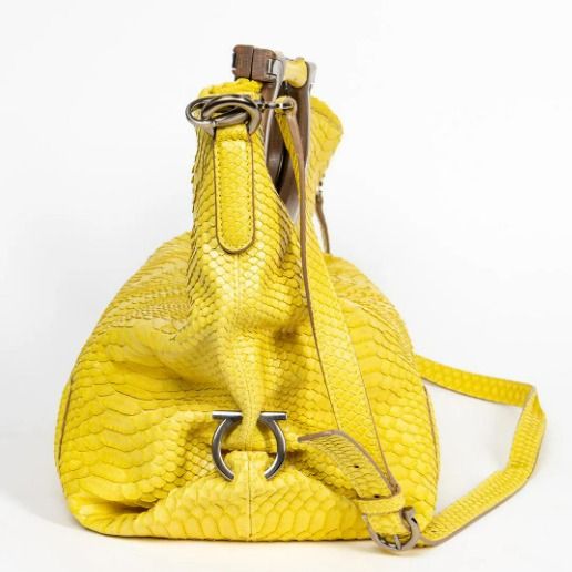 NEGOTIABLE! Salvatore Ferragamo Python Fiammetta Shoulder Bag Spring/Summer Coll 2010 (Category: Luxury Bags & Wallets) located in Cainta. Submitted by ahyish (Listing ID 1421164538, Image 3). Description: - Bright yellow leather handbag - Unique wooden handle - Detachable shoulder strap - Textured, snakeskin-like pattern - Silver-tone hardware - Spacious design - Suitable for everyday use .