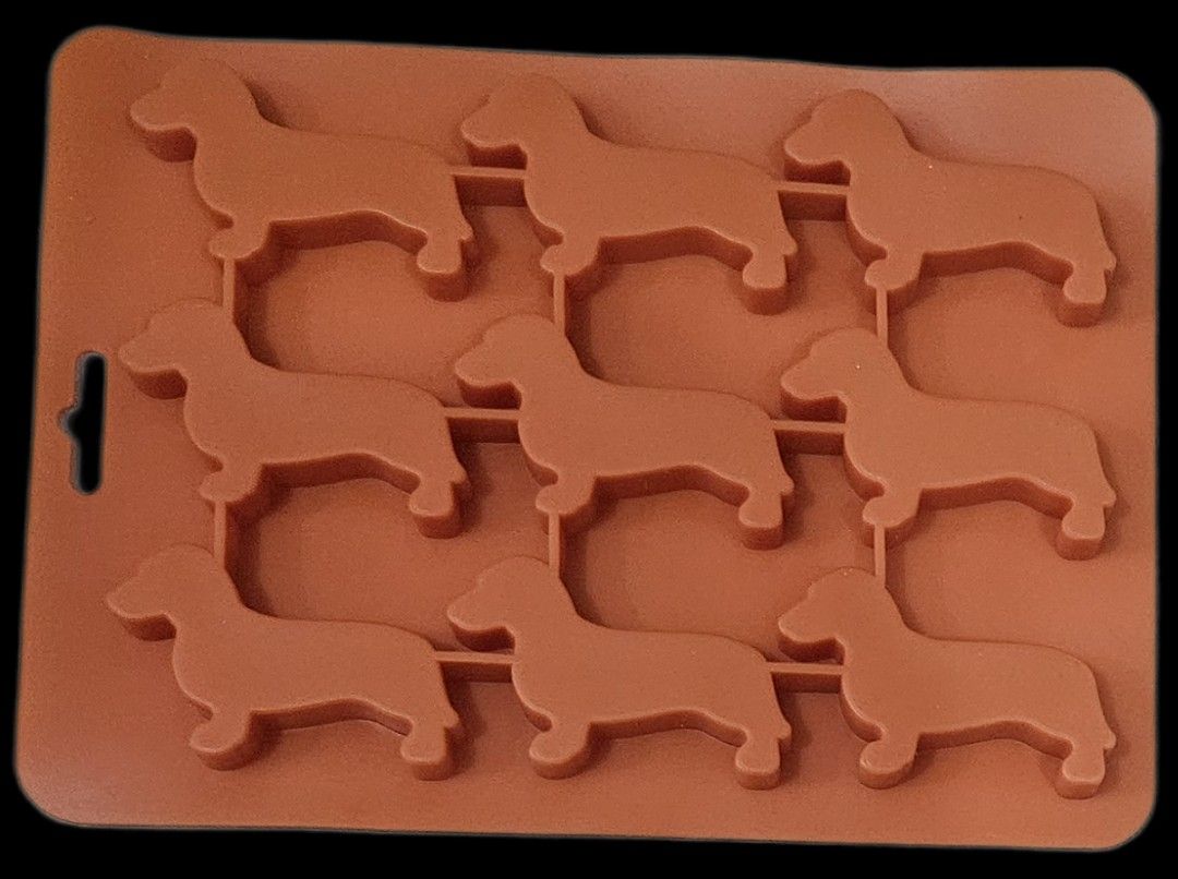 Silicone Baking Molds Set (Category: Bakeware) located in Makati City. Submitted by xzyche (Listing ID 1421124074, Image 2). Description: Set includes silicone molds for baking. There are dachshund dog shapes and various flower and cupcake shapes. Also included are cupcake liners in blue and yellow. Perfect for making treats for any occasion. These molds are flexible and easy to use. The dog and flower molds have been used once. The cupcake liner