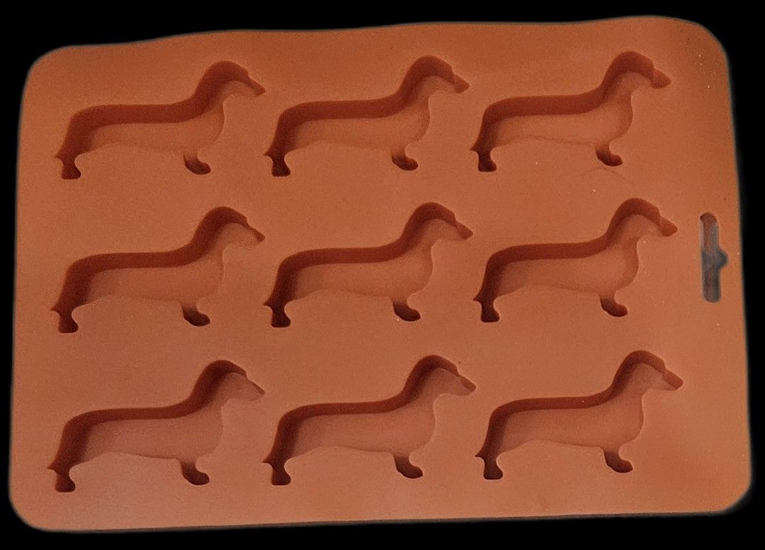 Silicone Baking Molds Set (Category: Bakeware) located in Makati City. Submitted by xzyche (Listing ID 1421124074, Image 3). Description: Set includes silicone molds for baking. There are dachshund dog shapes and various flower and cupcake shapes. Also included are cupcake liners in blue and yellow. Perfect for making treats for any occasion. These molds are flexible and easy to use. The dog and flower molds have been used once. The cupcake liner