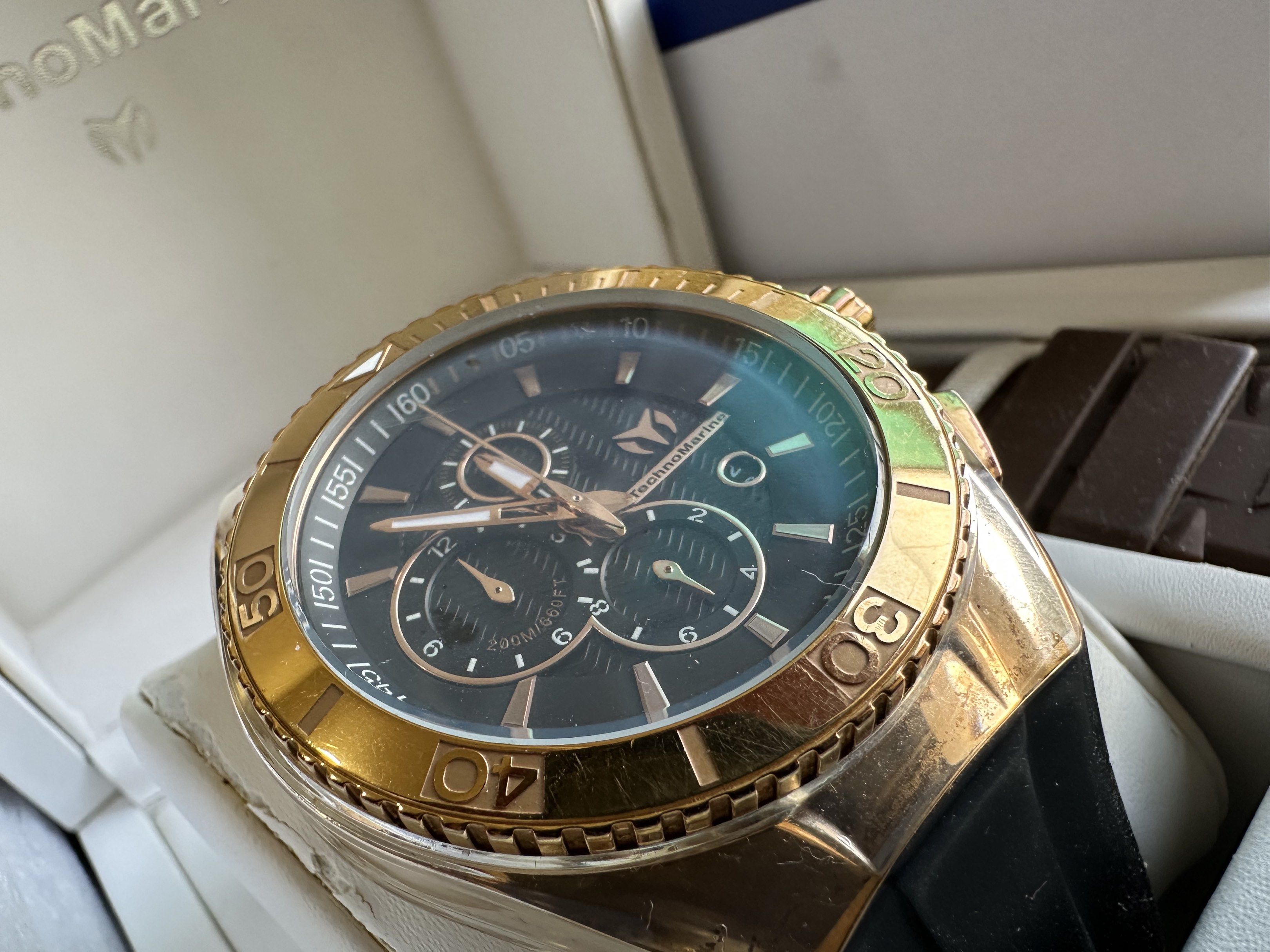 TechnoMarine Cruise Star Watch (Category: Men's Watches) located in Paranaque City. Submitted by daluho.stuff (Listing ID 1421175321, Image 2). Description: TechnoMarine Cruise Star watch with a black dial and gold-tone bezel. Includes two additional straps: white and brown. The watch features a black rubber strap and comes with its original box. The back of the watch indicates it is stainless steel and has a Japan movement..