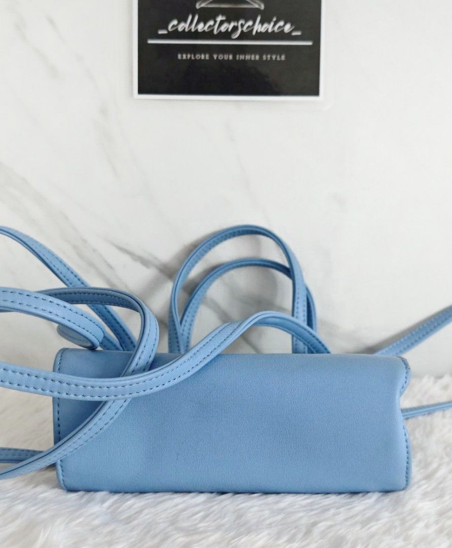Telfar Small Cerulean Shopping Bag (Category: Luxury Bags & Wallets) located in Makati City. Submitted by _collectorschoice_ (Listing ID 1421271681, Image 2). Description: ° This mini tote is constructed of faux leather in cerulean with the iconic raised Telfar logo at the front ° The shoulder bag has thin blue handles and a long crossbody strap ° The bag opens to a blue fabric interior ° Blue vegan leather ° Silver-tone hardware ° Flat handles &