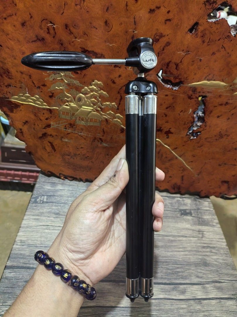 Tripod - Portable Camera Tripod (Category: Tripods & Monopods) located in Cebu City. Submitted by dudes_villanueva (Listing ID 1421137748, Image 1). Description: Tripod - Portable Camera Tripod Brand: Luft - Made in Japan 📌It has a black and silver telescopic design. 📌The legs fold together for a compact, handheld form factor. 📌Made of metal and possibly some plastic components. 📌It features a ball head mount for adjustable positioning. 📌In 