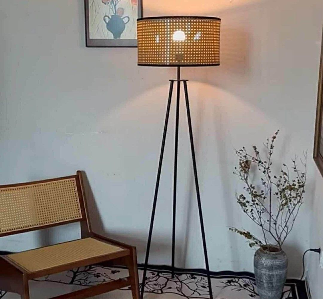 Tripod Floor Lamp with Rattan Shade (Category: Lighting) located in Makati City. Submitted by gineth24 (Listing ID 1421164389, Image 1). Description: - Stylish floor lamp with a black tripod base - Features a cylindrical rattan shade with a woven texture - Provides warm, ambient lighting - Ideal for living rooms and bedrooms - Dimensions: 150cm height, 42cm shade diameter, 23cm shade height.