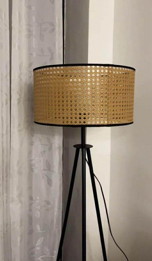 Tripod Floor Lamp with Rattan Shade (Category: Lighting) located in Makati City. Submitted by gineth24 (Listing ID 1421164389, Image 3). Description: - Stylish floor lamp with a black tripod base - Features a cylindrical rattan shade with a woven texture - Provides warm, ambient lighting - Ideal for living rooms and bedrooms - Dimensions: 150cm height, 42cm shade diameter, 23cm shade height.