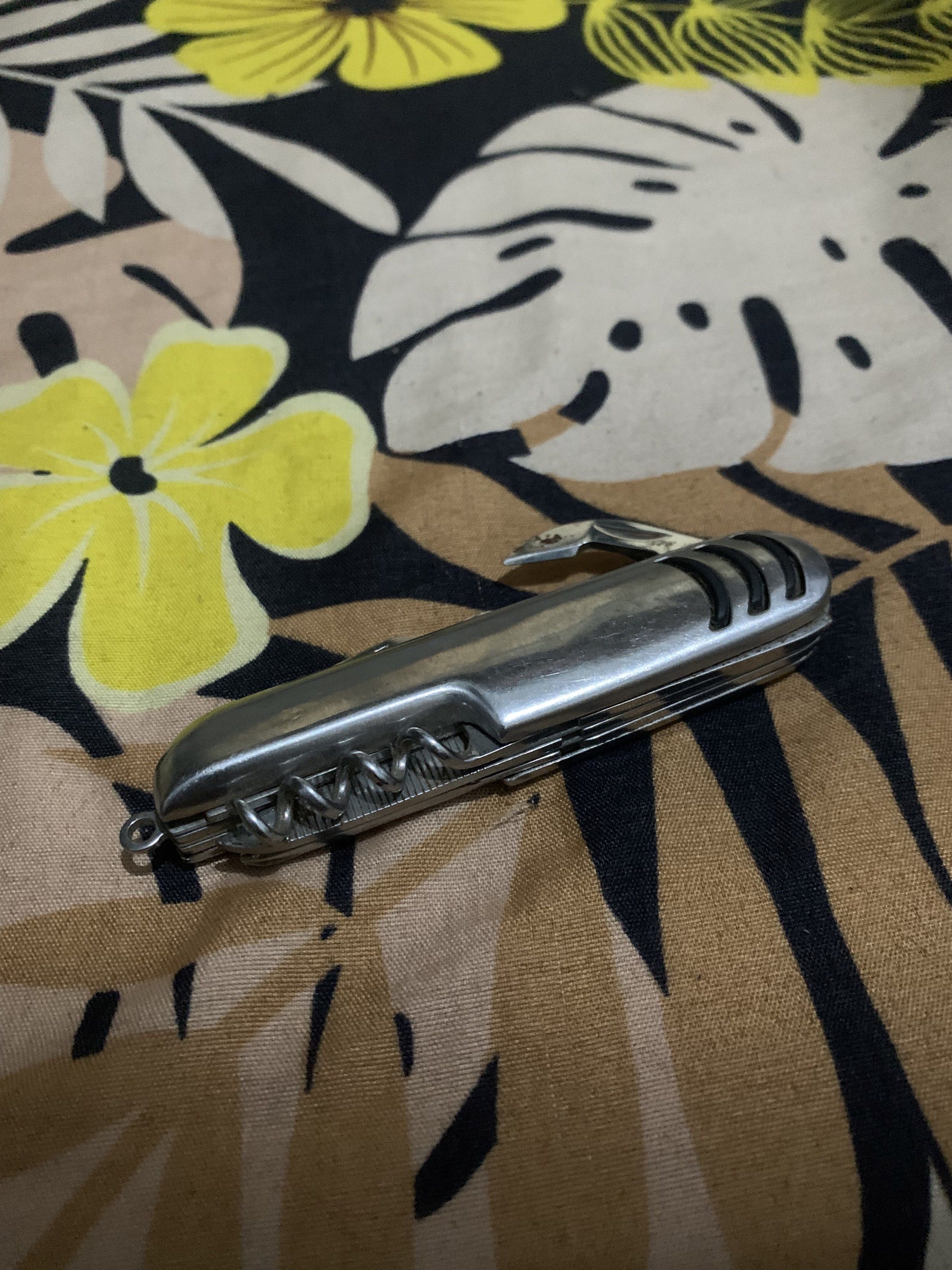 Vintage Multi-tool Knife (Category: Knives & Chopping Boards) located in Manila. Submitted by declutteringog7 (Listing ID 1421144042, Image 2). Description: - Multi-tool knife - Features: Knife blade, scissors, corkscrew, and more - Silver finish - Compact and easy to carry - Well-maintained - Functional for various tasks.