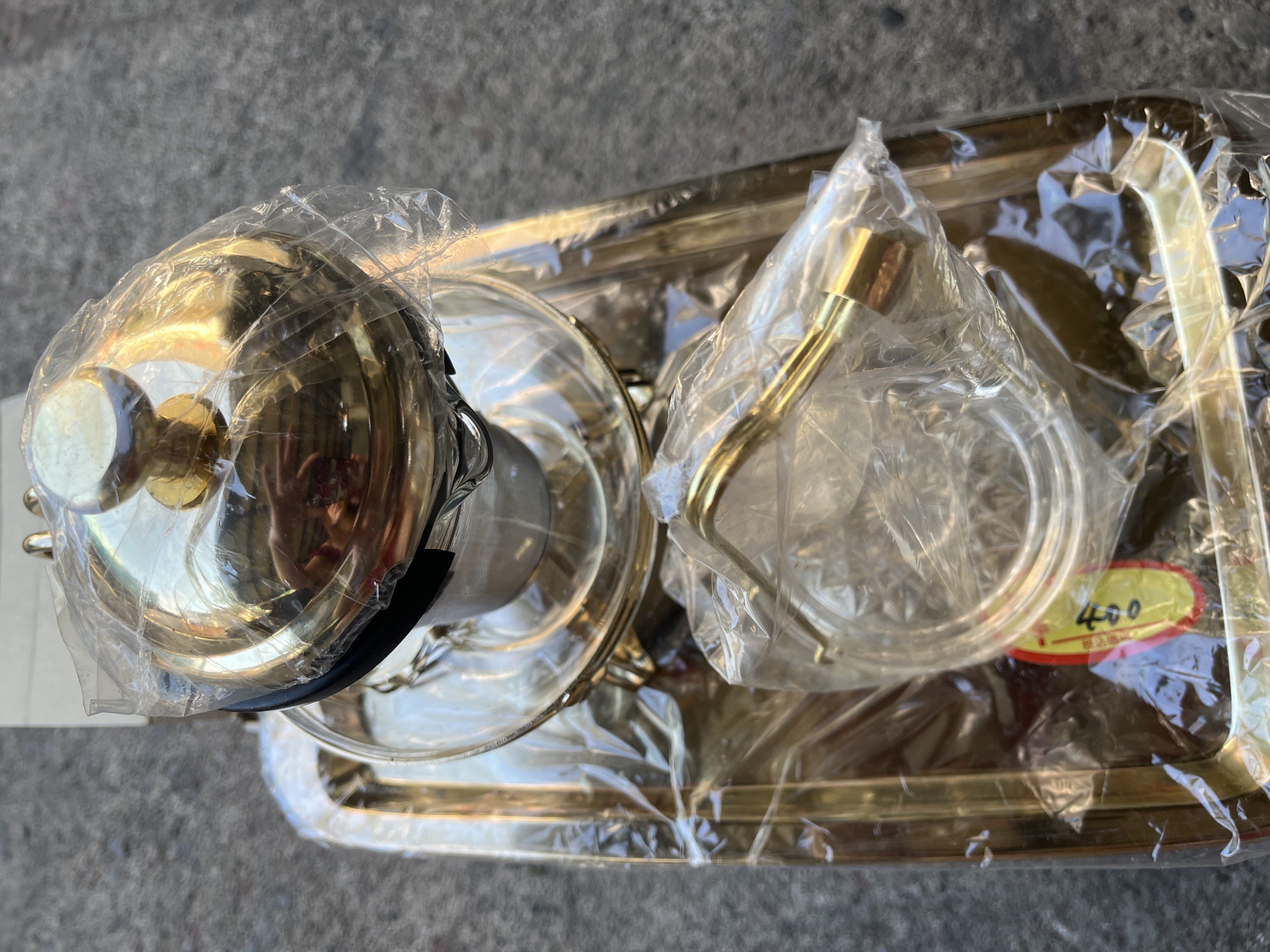 Vintage Tea Set with Tray (Category: Coffee & Tea Tableware) located in Calasiao. Submitted by xwbj4ycjw975281 (Listing ID 1421194203, Image 3). Description: - Elegant glass teapot with gold-colored frame - Matching gold-finished tray - Teacup stand included - Features a lid and internal strainer - Unused, in original packaging.