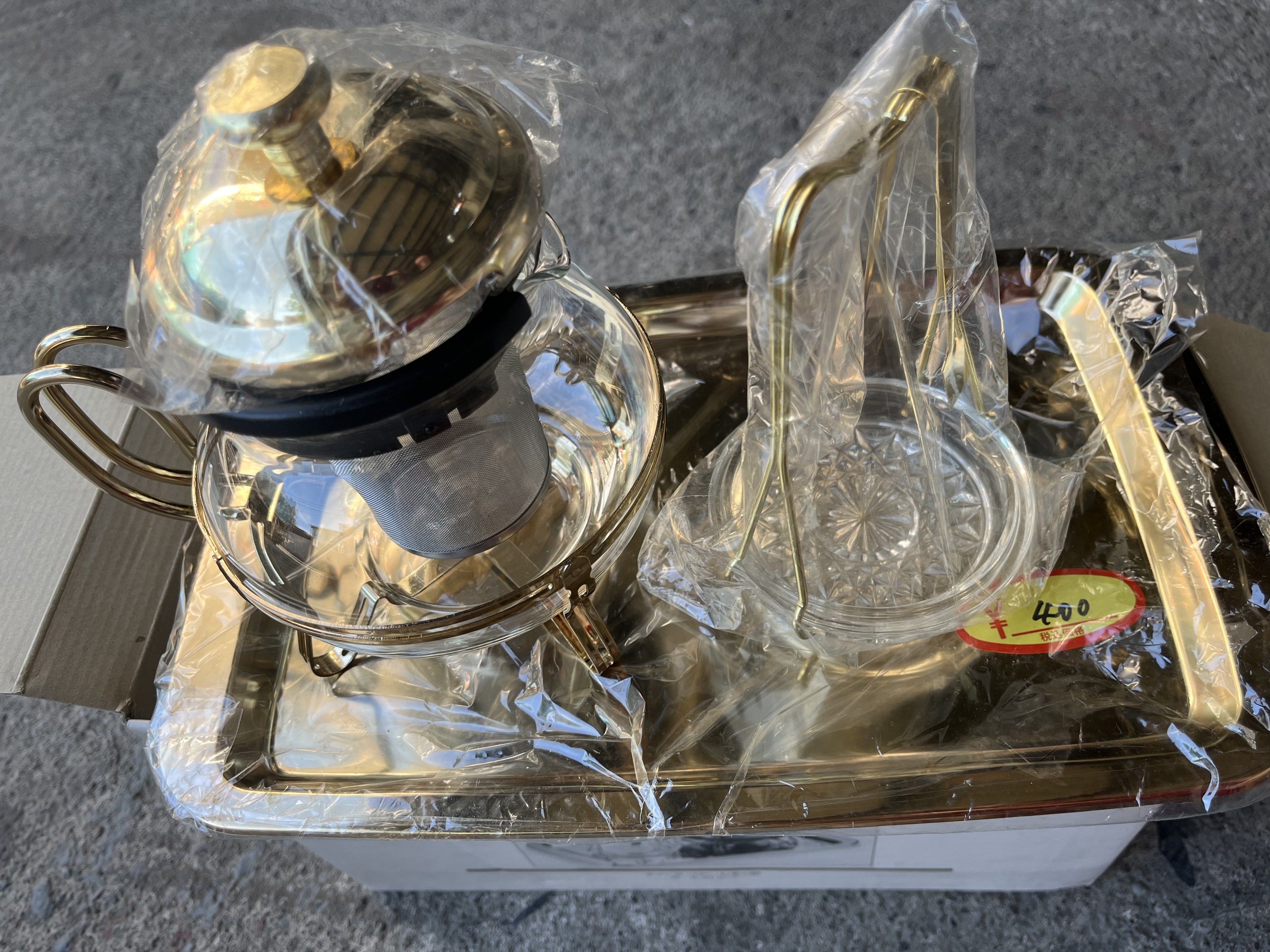 Vintage Tea Set with Tray (Category: Coffee & Tea Tableware) located in Calasiao. Submitted by xwbj4ycjw975281 (Listing ID 1421194203, Image 2). Description: - Elegant glass teapot with gold-colored frame - Matching gold-finished tray - Teacup stand included - Features a lid and internal strainer - Unused, in original packaging.