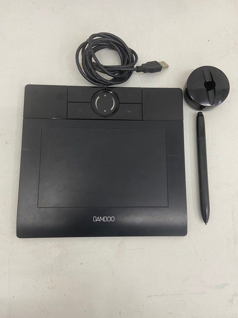 Wacom Bamboo MTE-450A/K Drawing Tablet (Category: Other Accessories) located in Quezon City. Submitted by thrifthive (Listing ID 1421186778, Image 1). Description: - Wacom Bamboo drawing tablet (MTE-450A/K). - Includes pen, USB cable, and pen stand. - Black surface with navigation dial and function buttons. - Ideal for digital art and creative work. - Compact and portable design..