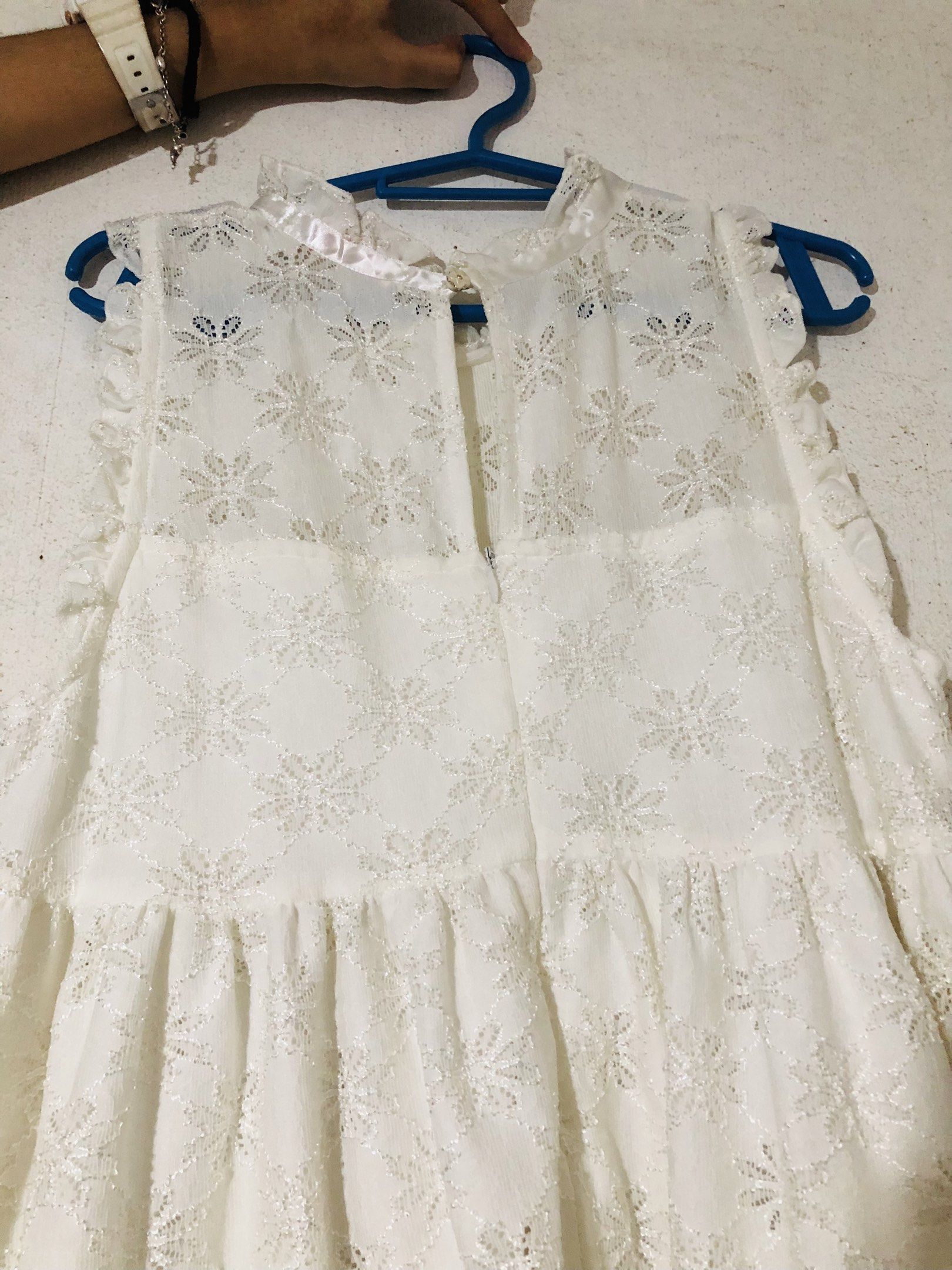White Lace Dress (Category: Dresses) located in Pasay City. Submitted by declutterwifmeee (Listing ID 1421154807, Image 2). Description: - Tindimxxx white lace dress - Size: L but fits s-L po yan - Floral pattern - Ruffled hem - High neckline with button closure - Sleeveless - A-line silhouette.