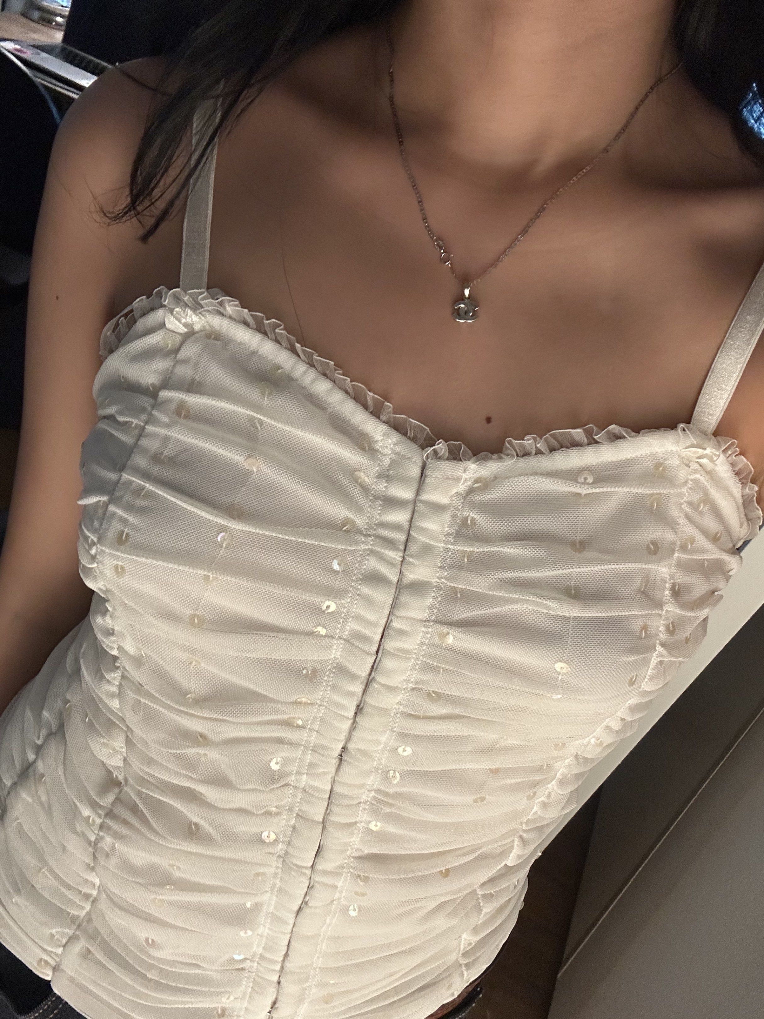 white ruched top with sequins (Category: Sleeveless) located in Cainta. Submitted by brberry (Listing ID 1421197060, Image 2). Description: 🪭 white ruched hook eye closure tank top with ruffles and sequins from a shop in solana market 🪭 has adjustable straps and 🪭 size: XS-S 🪭 rfs: not my style anymore 🪭 shipping: buyer books with any app + shoulders the fee / can meet up in UST.