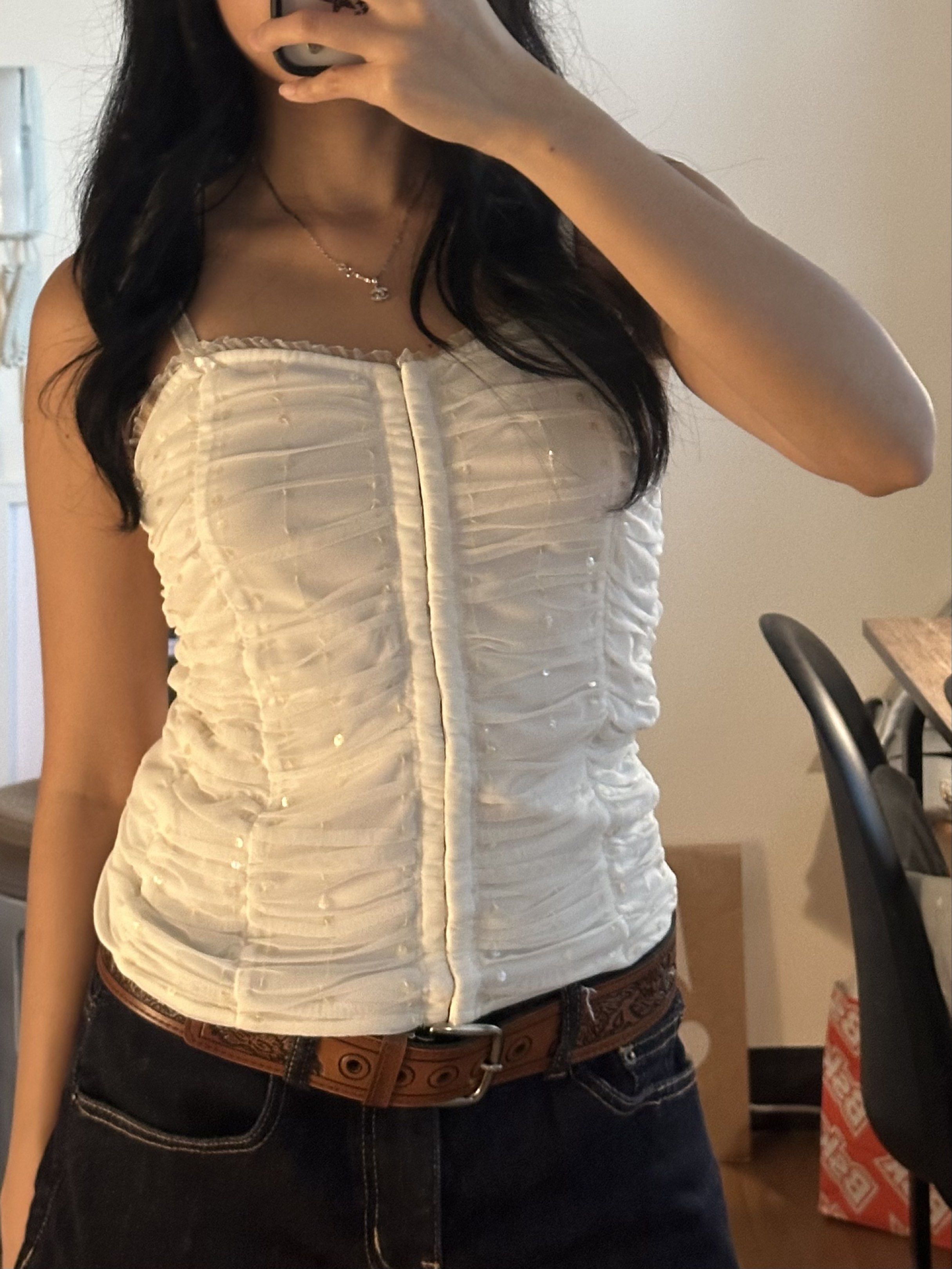 white ruched top with sequins (Category: Sleeveless) located in Cainta. Submitted by brberry (Listing ID 1421197060, Image 1). Description: 🪭 white ruched hook eye closure tank top with ruffles and sequins from a shop in solana market 🪭 has adjustable straps and 🪭 size: XS-S 🪭 rfs: not my style anymore 🪭 shipping: buyer books with any app + shoulders the fee / can meet up in UST.