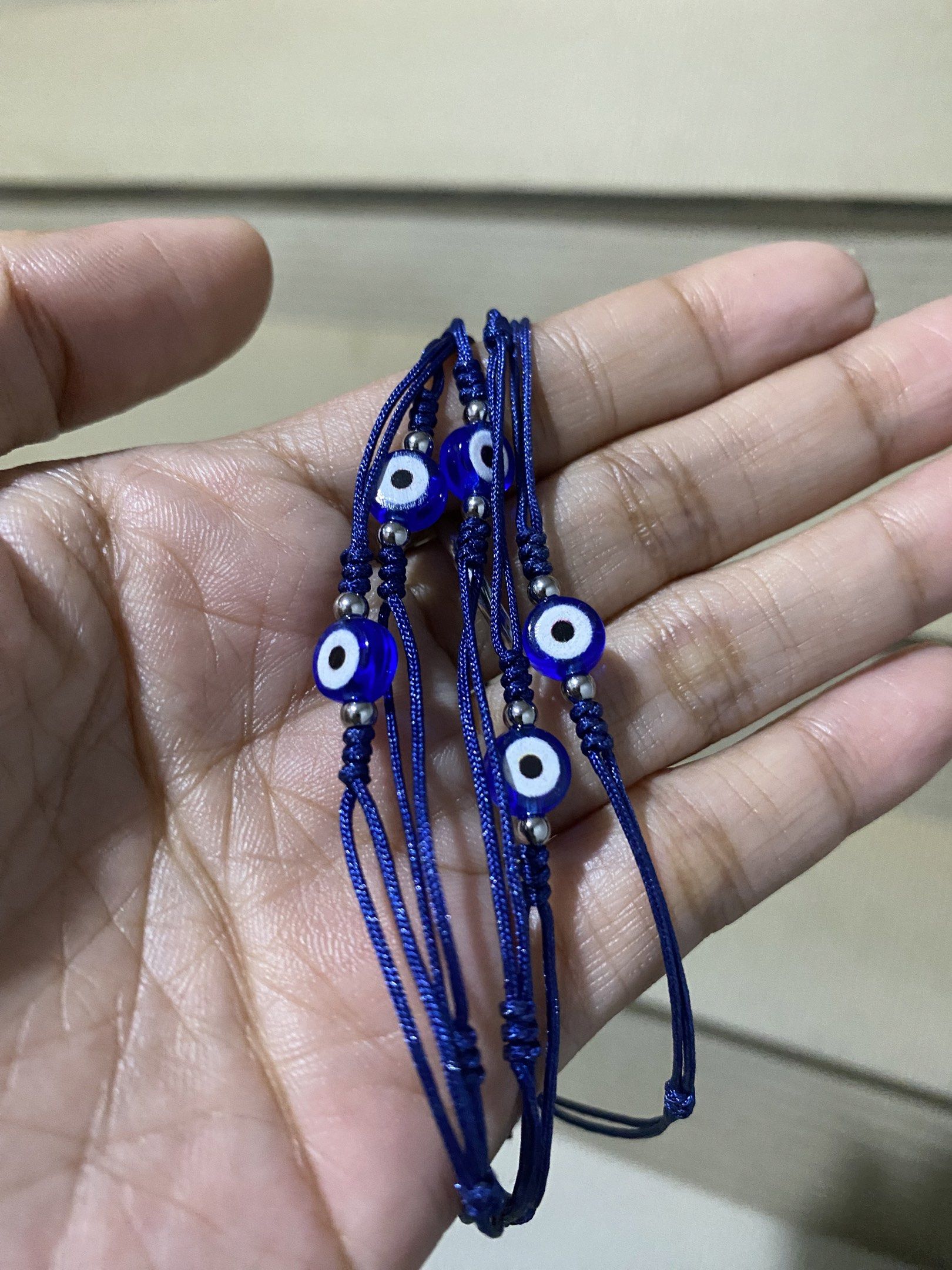 6mm Evil Eye Bracelet (stainless beads spacer) (Category: Bracelets) located in General Trias. Submitted by artycles (Listing ID 1420076328, Image 1). Description: - Features two round evil eye charms. - Dark blue cord. - Adjustable bracelet. - Simple and elegant design..