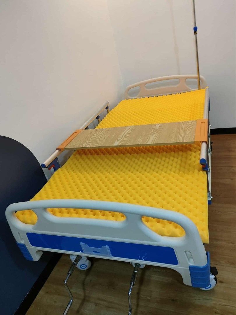 Adjustable Hospital Bed with Mattress (Category: Bed Frames & Mattresses) located in Quezon City. Submitted by medicsupplies_09 (Listing ID 1421329576, Image 1). Description: - Adjustable hospital bed - Includes bed and egg mattress - Features a wooden tray - Equipped with wheels for easy mobility - Side rails for added safety - Comes with an IV pole - White and blue frame.
