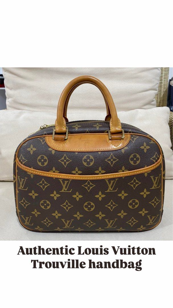 Authentic Louis Vuitton Trouville Handbag (Category: Luxury Bags & Wallets) located in San Pablo. Submitted by with.jacque (Listing ID 1421450998, Image 1). Description: - Authentic Louis Vuitton Trouville handbag - Iconic monogram canvas - Structured shape with dual top handles - Secure zip closure - Interior with multiple compartments - Exterior shows wear on corners and handles - Elegant gold-toned hardware.