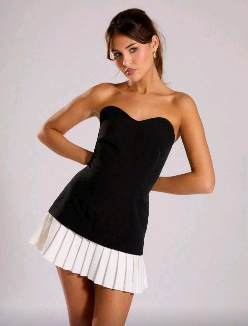 Black and White Mini Dress (Category: Dresses) located in Taguig. Submitted by chedam (Listing ID 1421448674, Image 2). Description: - Mini dress with black bodice and white pleated skirt - Sweetheart neckline - Sleeveless - Suitable for various occasions - Chic and stylish look - Ideal for a night out or special event.