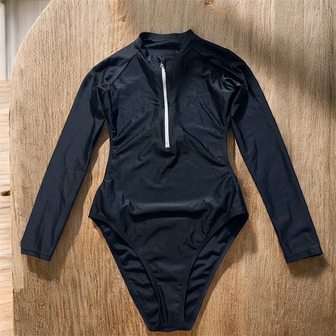 Black Long Sleeve Swimsuit (Category: Bikinis & Swimsuits) located in Manila. Submitted by AngelResty (Listing ID 1421437115, Image 2). Description: - Black one-piece swimsuit - Long sleeves - Front zipper - High-cut leg design - Unique open back - Smooth, stretchy material - Ideal for swimming and water activities.