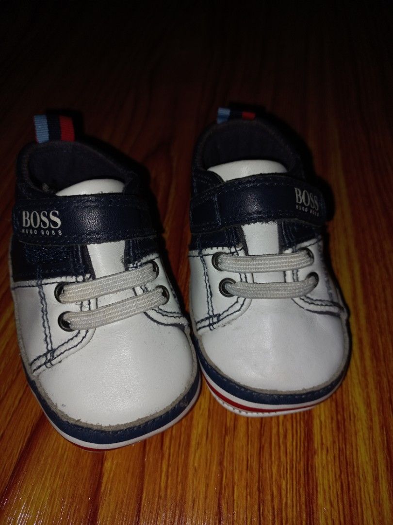 BOSS Baby Shoes (Category: Babies & Kids Fashion) located in Manila. Submitted by enzierose (Listing ID 1421390514, Image 1). Description: - Adorable BOSS baby shoes - Color: White and Navy Blue - Easy hook-and-loop closure - Red and blue stripe detail - Size: EUR 18, UK 2, US 3 - Made in China.
