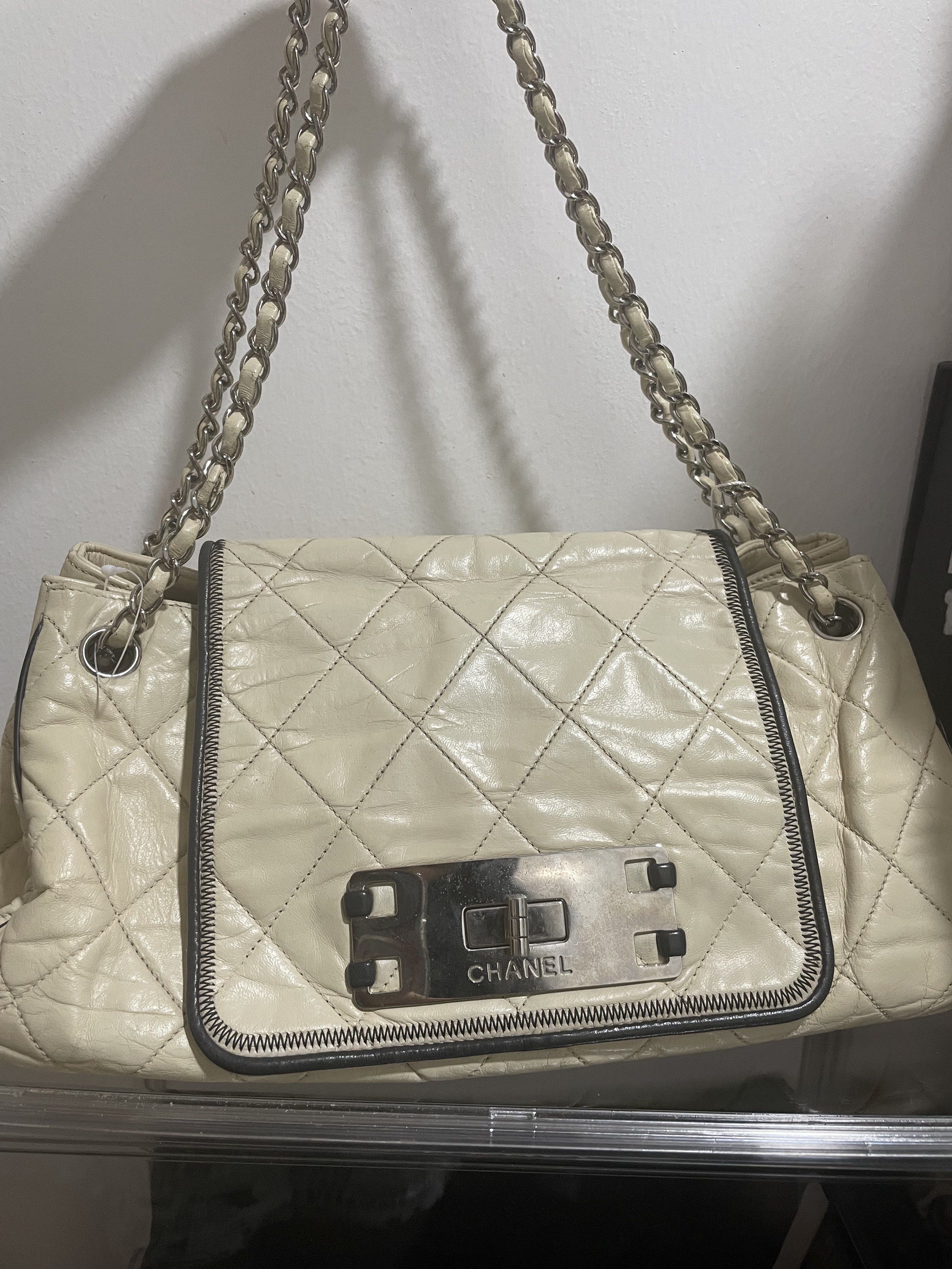 Chanel Accordion Reissue Flap Bag (Category: Luxury Bags & Wallets) located in Davao. Submitted by prettythings.ph (Listing ID 1421434839, Image 1). Description: Authentic Chanel Accordion Reissue Flap Bag in cream color. Features a quilted design with a silver chain strap. The bag has a metal clasp closure with the Chanel logo. Includes an authenticity certificate from LegitGrails. The interior has a Chanel logo and a serial number tag. Made in 
