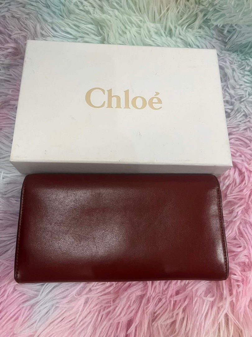 Chloe Leather Wallet (Category: Luxury Bags & Wallets) located in Manila. Submitted by euphoriathriftco (Listing ID 1421428396, Image 2). Description: - Authentic Chloe wallet - Rich burgundy color - Gold-tone 'C' logo - Multiple card slots - Zippered compartment - Comes with original box.