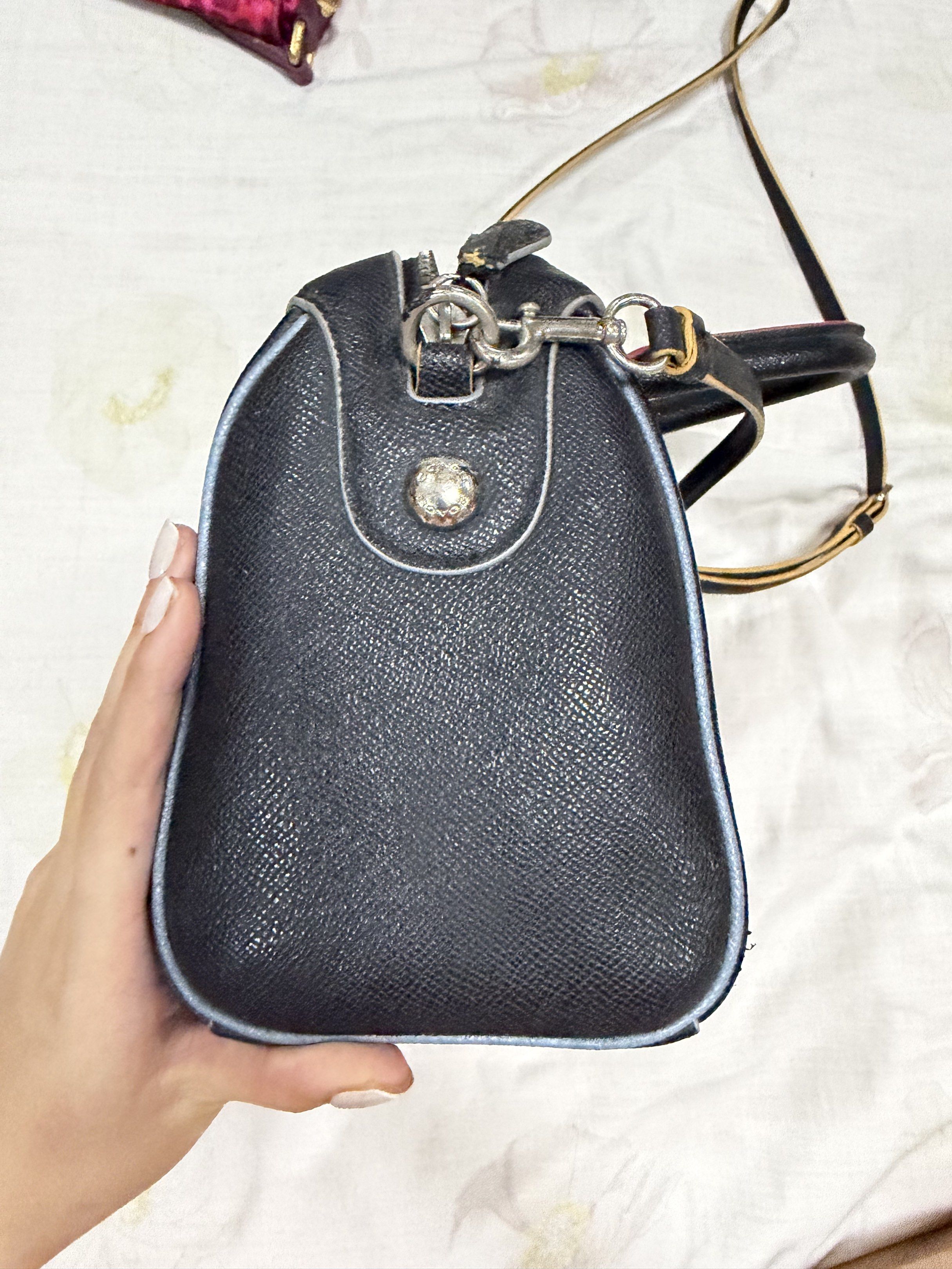 Coach Black Leather Satchel Bag (Category: Luxury Bags & Wallets) located in Quezon City. Submitted by chasy9 (Listing ID 1421421018, Image 2). Description: - Black leather satchel bag - Top handle and detachable shoulder strap - Silver-tone zipper and hardware - Red trim on handles - Light blue trim around edges - Coach hang tag - Black fabric interior.