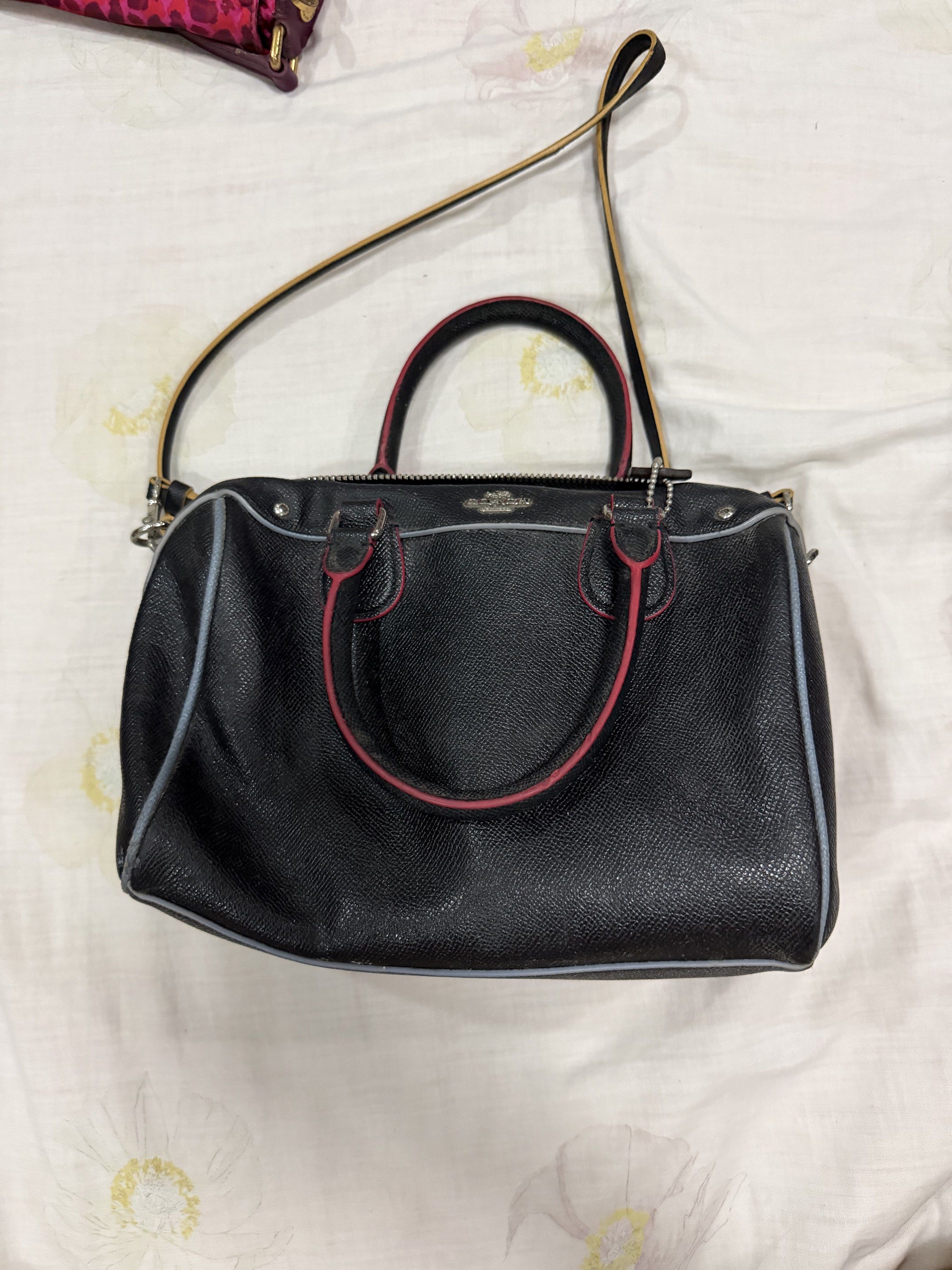 Coach Black Leather Satchel Bag (Category: Luxury Bags & Wallets) located in Quezon City. Submitted by chasy9 (Listing ID 1421421018, Image 1). Description: - Black leather satchel bag - Top handle and detachable shoulder strap - Silver-tone zipper and hardware - Red trim on handles - Light blue trim around edges - Coach hang tag - Black fabric interior.
