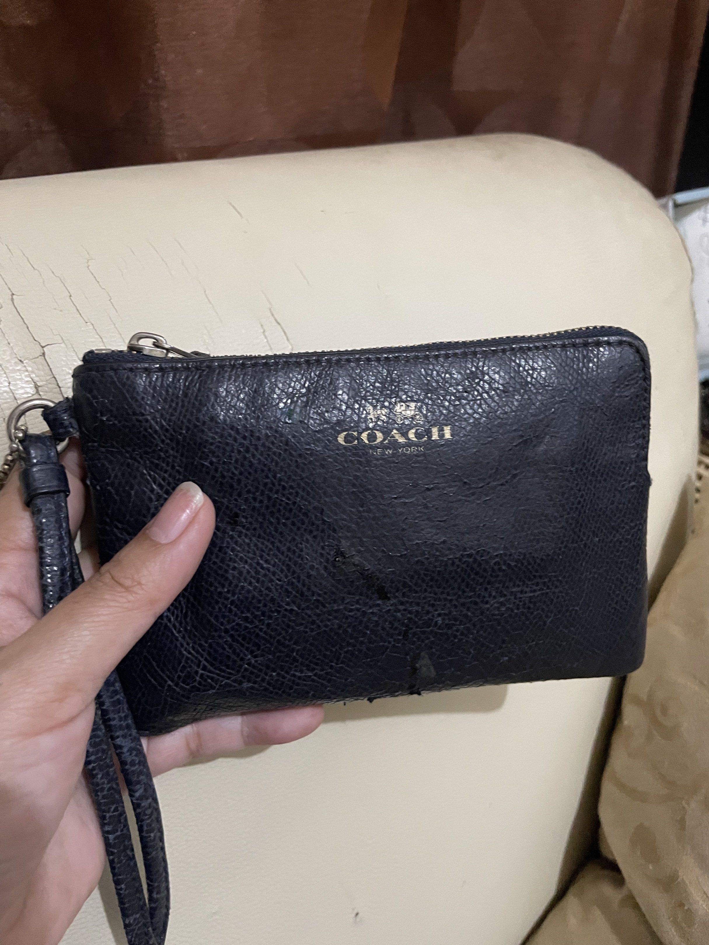 Coach Navy Blue Zip Wallet (Category: Wallets & Card holders) located in Paranaque City. Submitted by jhingpreloveditems (Listing ID 1415900723, Image 1). Description: - Navy blue Coach wallet - Zip closure - Includes wrist strap - Comes with care instructions car - Interior: Card slots and cash space - 7/10 conditions - with scratches in front - Compact size, ideal for everyday use.