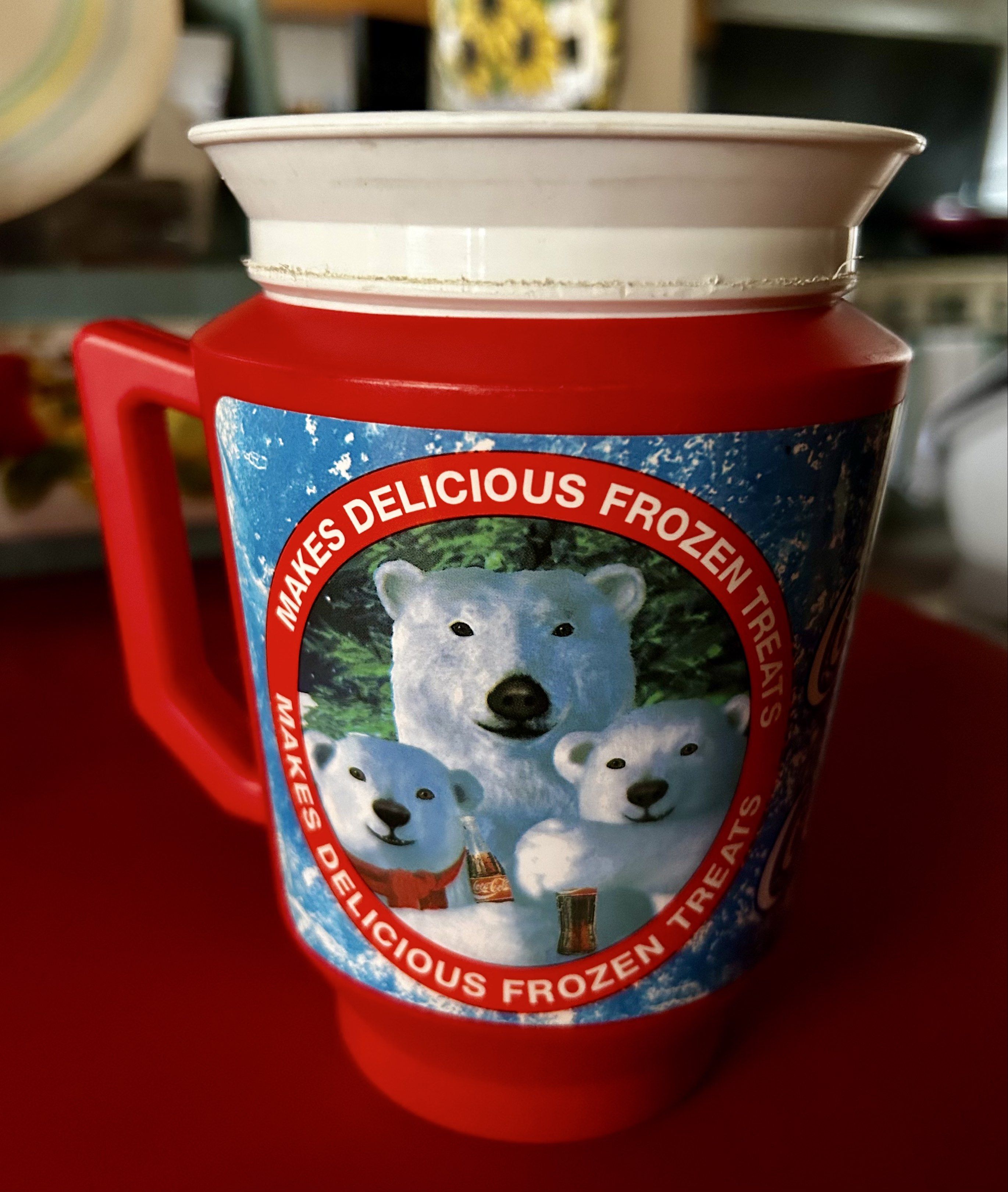 Vintage Coca-Cola Polar Bear Mug (Category: Coffee & Tea Tableware) located in Las Pinas. Submitted by rjmwings (Listing ID 1421358873, Image 1). Description: Vintage Coca-Cola mug featuring polar bear graphics. Bought in 1997 in Los Angeles, CA. It has a red exterior with a white rim and handle. The mug is designed to make delicious frozen treats. The base of the mug is red, and the interior is white. The mug has the Coca-Cola logo and the text 
