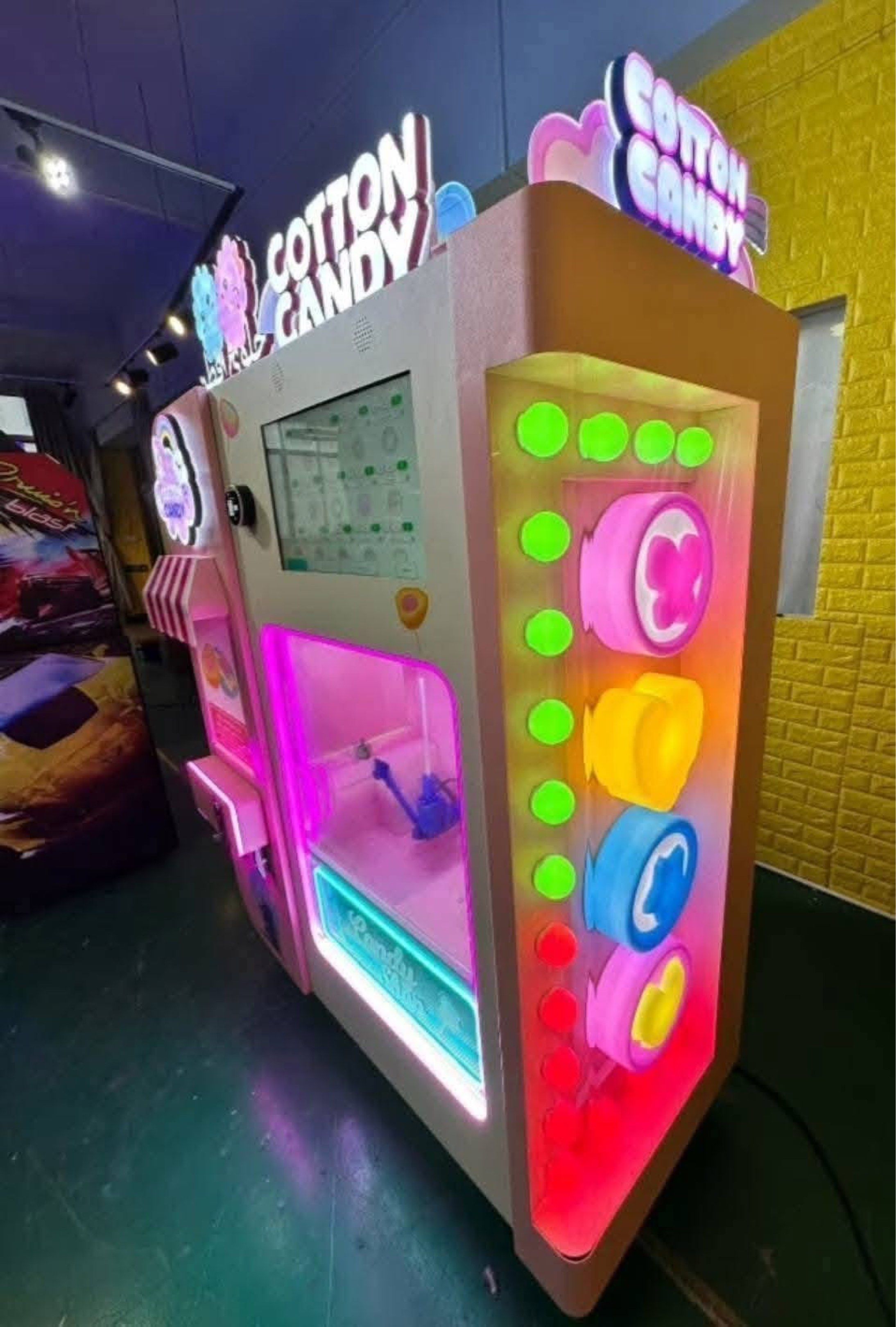 Cotton Candy Vending Machine (Category: Coffee Machines & Makers) located in San Pablo. Submitted by vennisa.sportssupplies (Listing ID 1421362201, Image 1). Description: Cotton candy vending machine is perfect for parties or events. It features a colorful design with LED lights and a user-friendly interface. The machine dispenses cotton candy and has a built-in screen. It has a candy shop design and is likely to attract customers. It is a great 